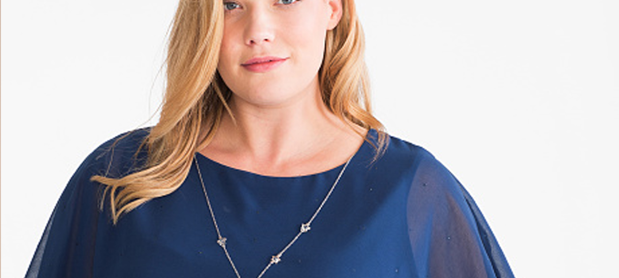 A woman with blonde hair and a blue top.