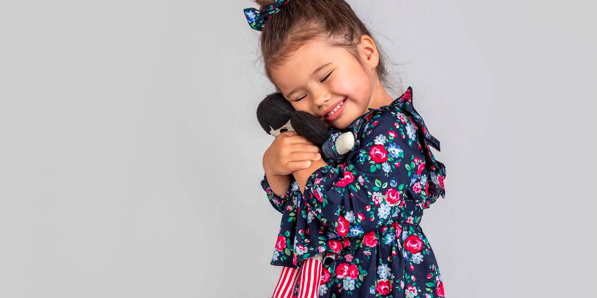 little girl wearing blue and pink flower dress by oobi