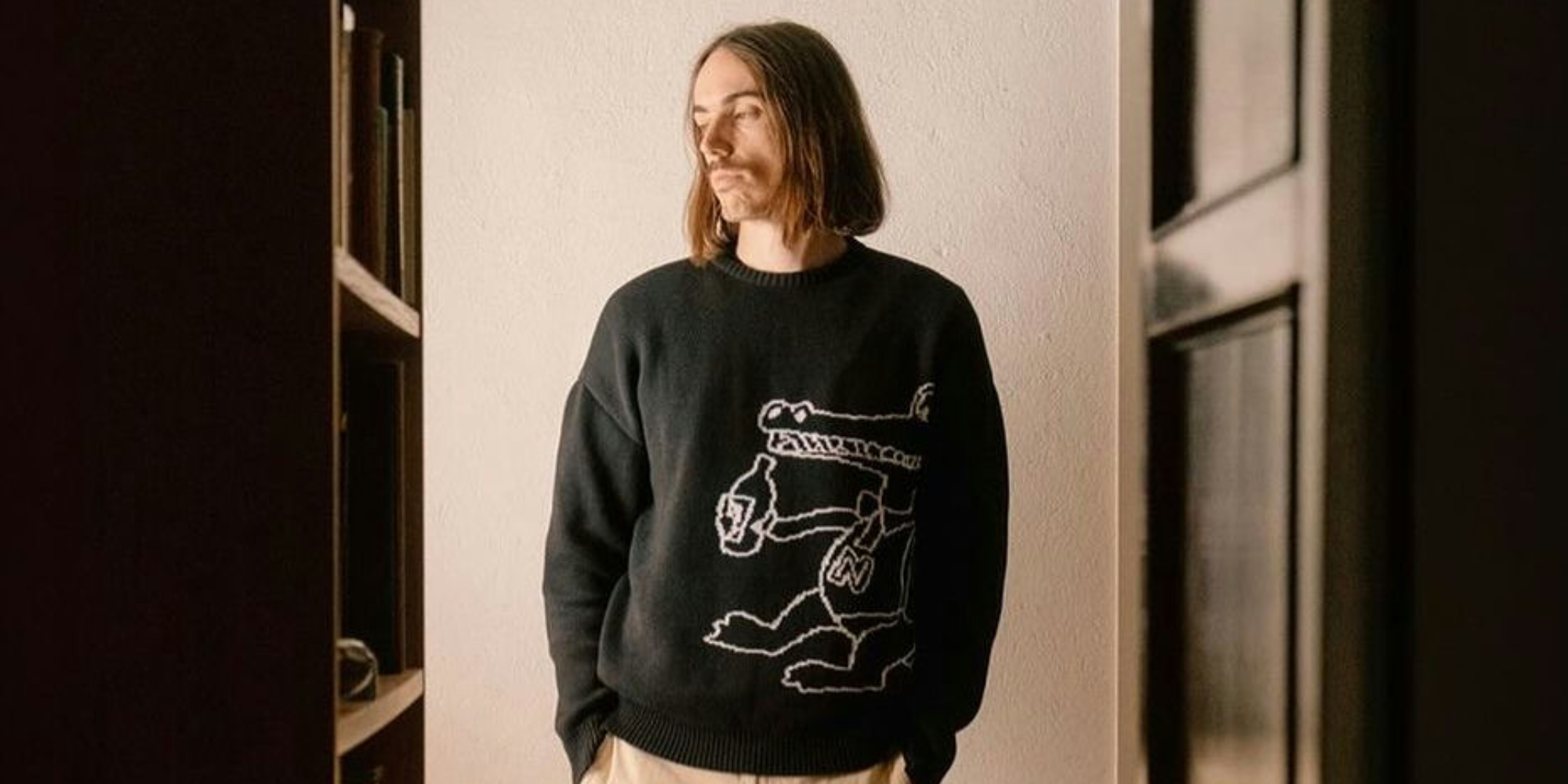 Someone wearing a printed jumper by more sustainable brand Brothers We Stand.