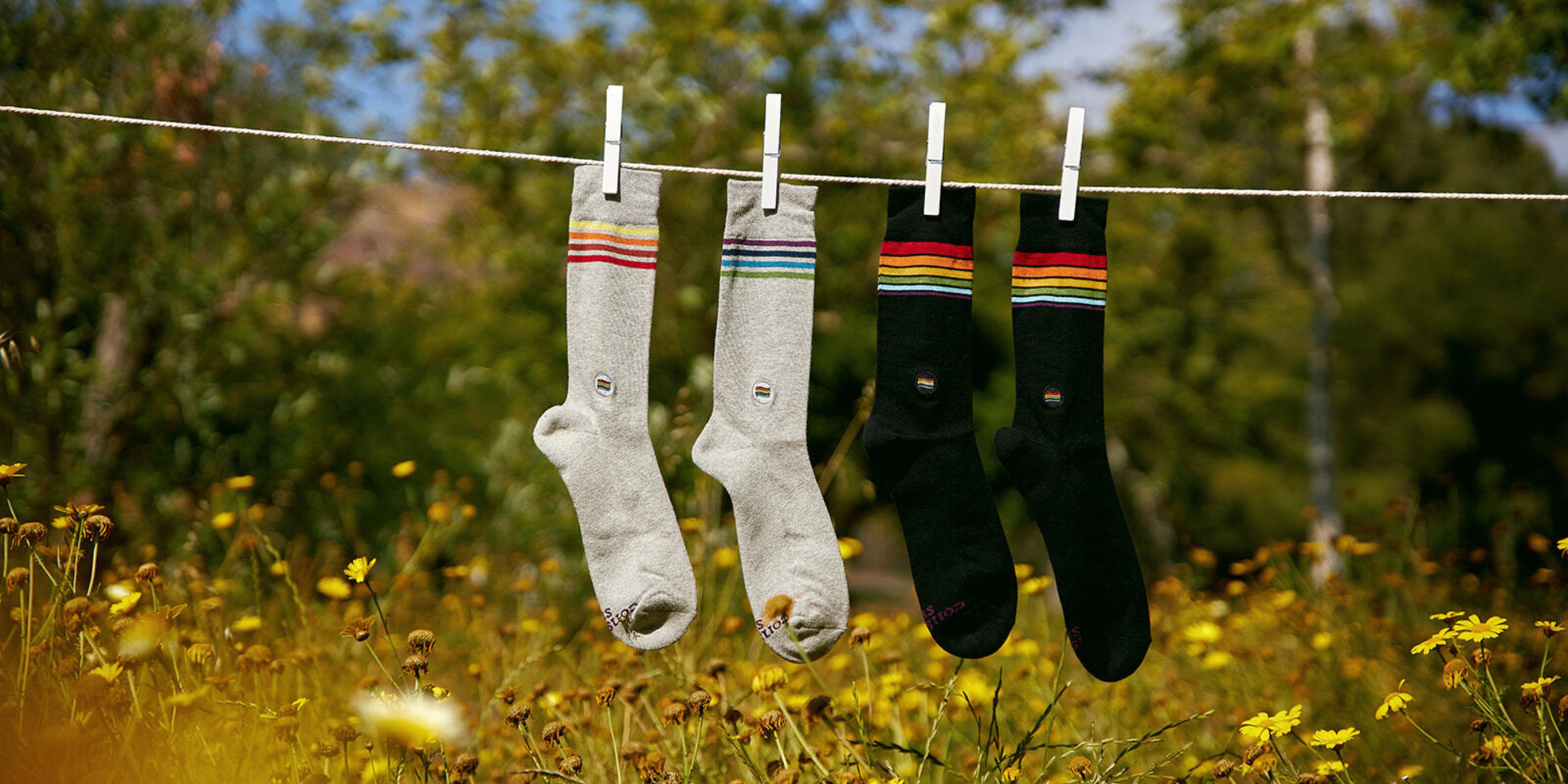 Pair of white and black socks hanging on a line by Conscious Step.