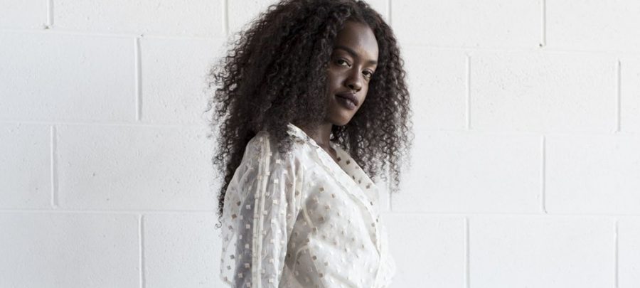 A woman wears a white organza coat