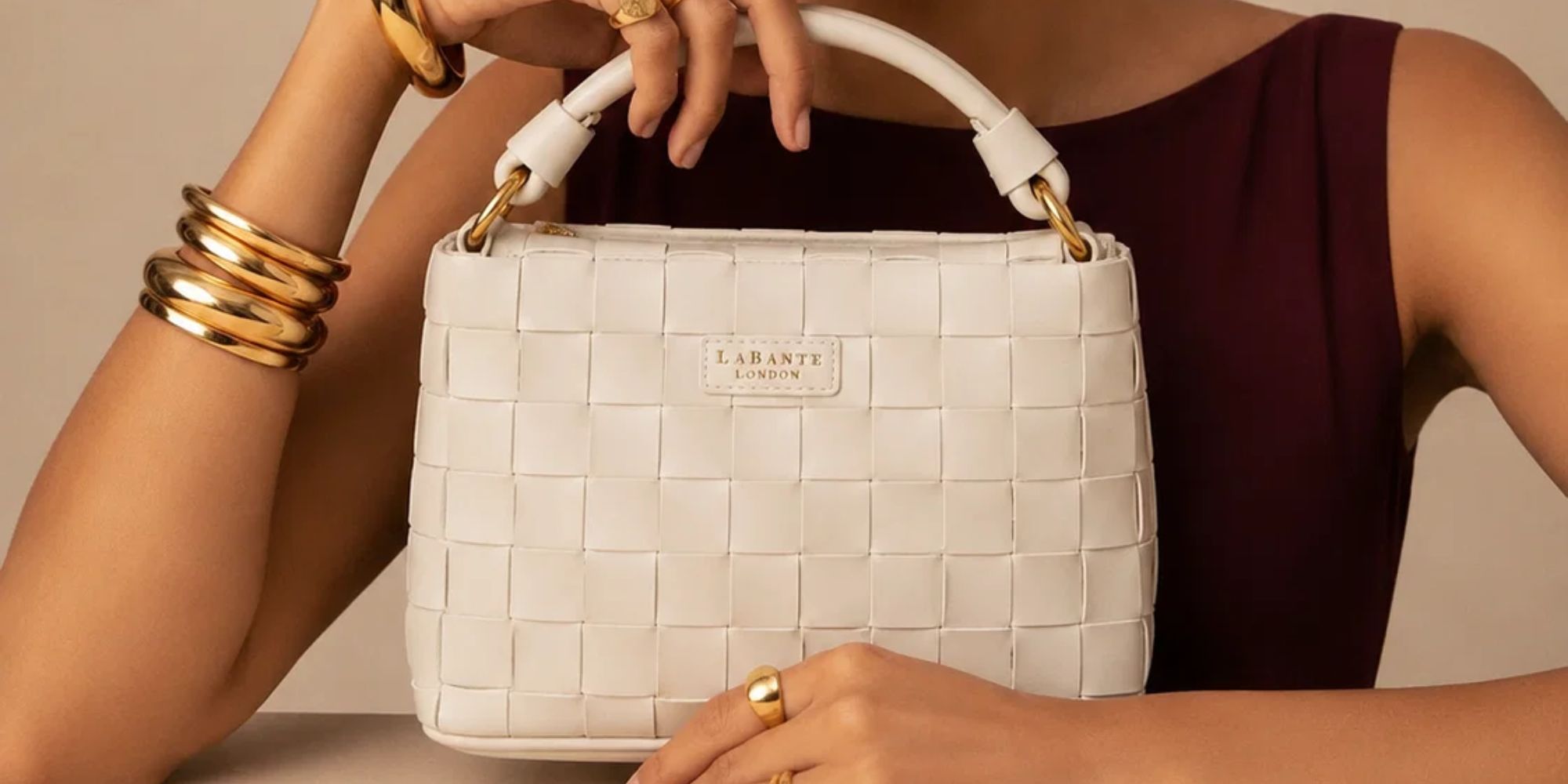 person holding a white woven bag from vegan brand labante