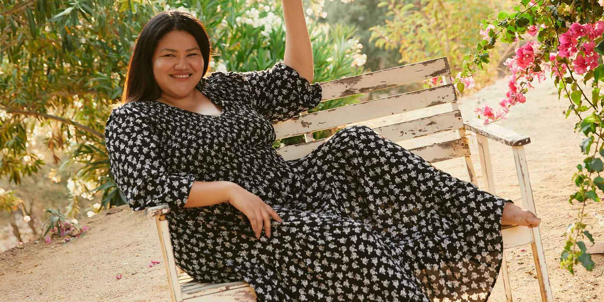 plus size woman of colour wearing black sustainable dress by Christy Dawn