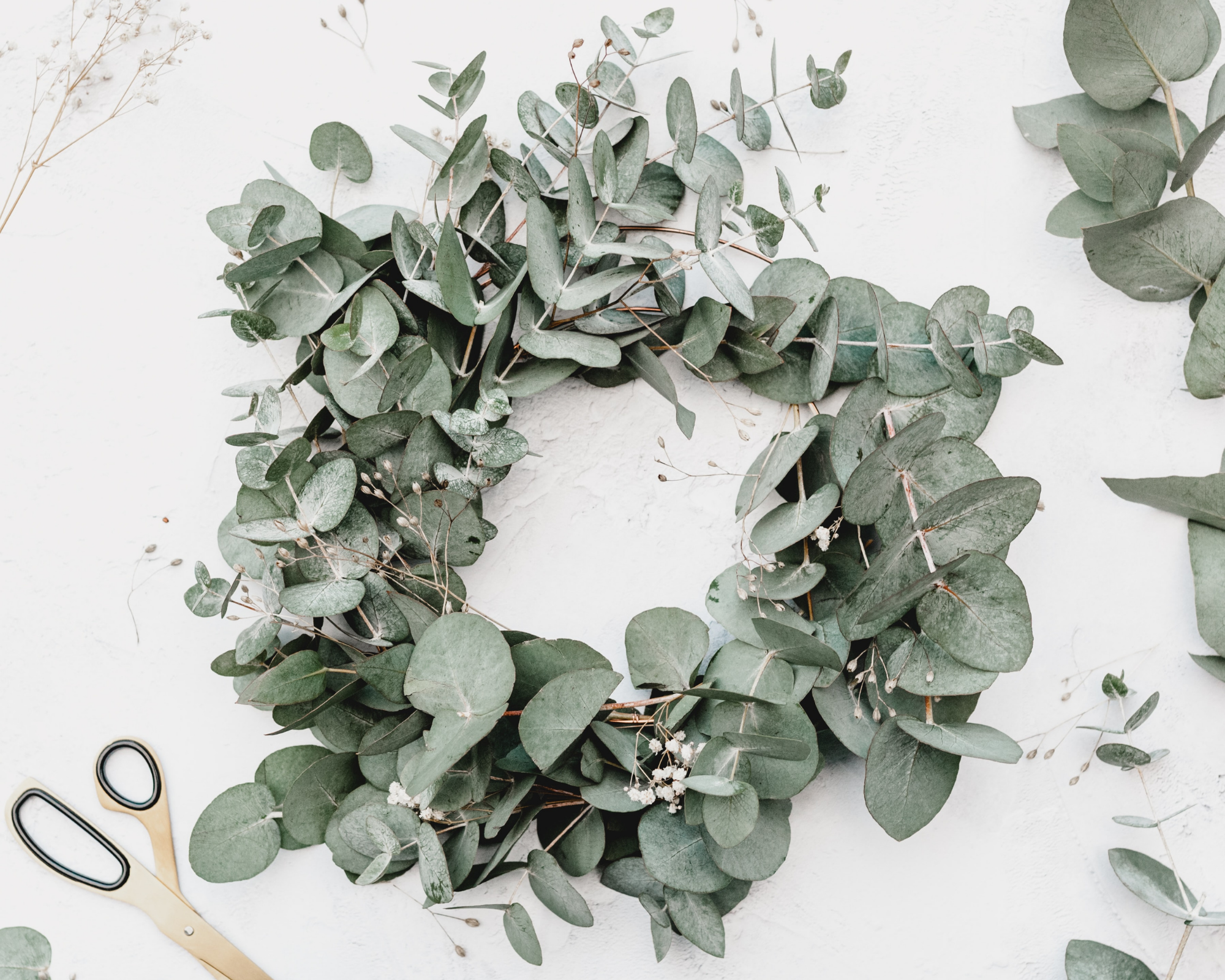 minimalist Christmas baby eucalyptus wreath and gold scissors