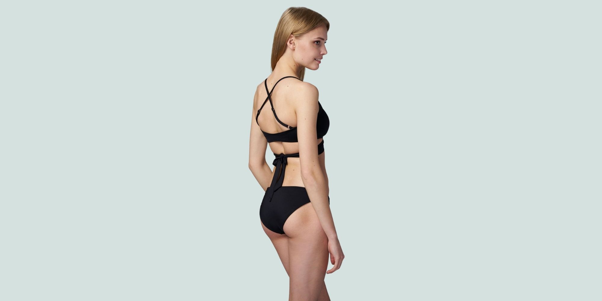 Person wearing a black bikini set by Loop Swim.
