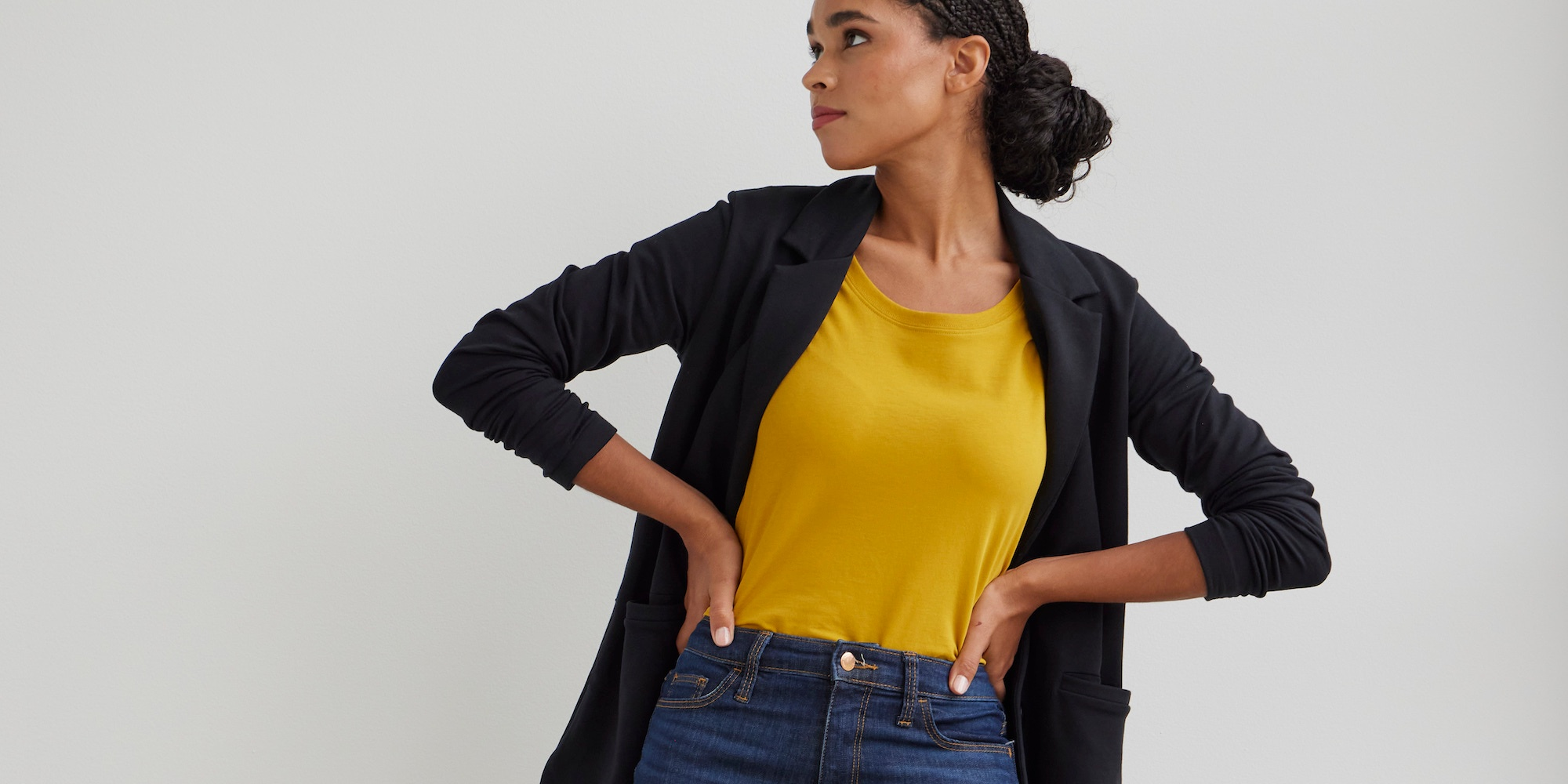 Someone in top, cardigan and jeans by Fair Indigo.