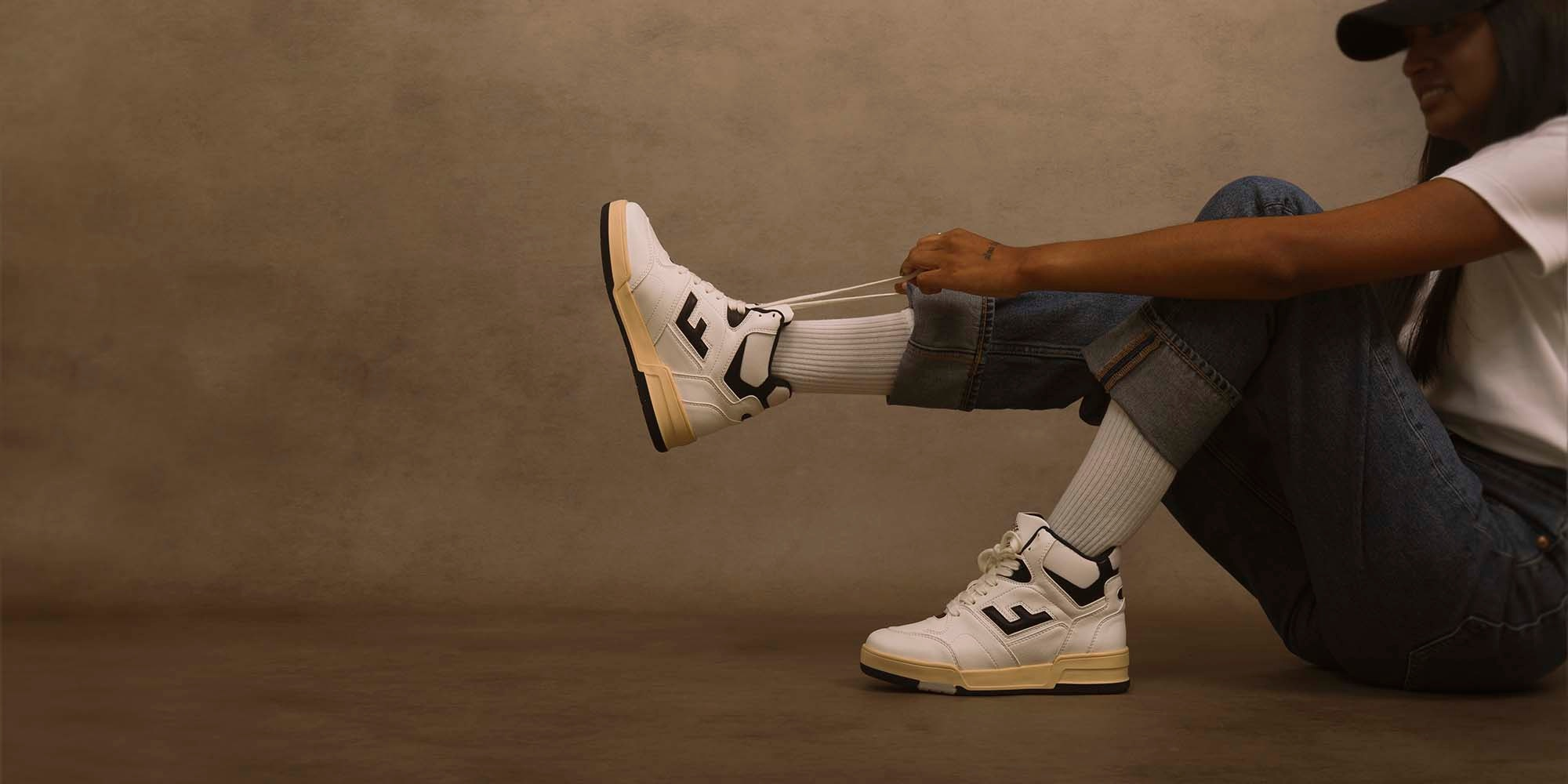 Someone putting on sneakers by Flamingo's Life.