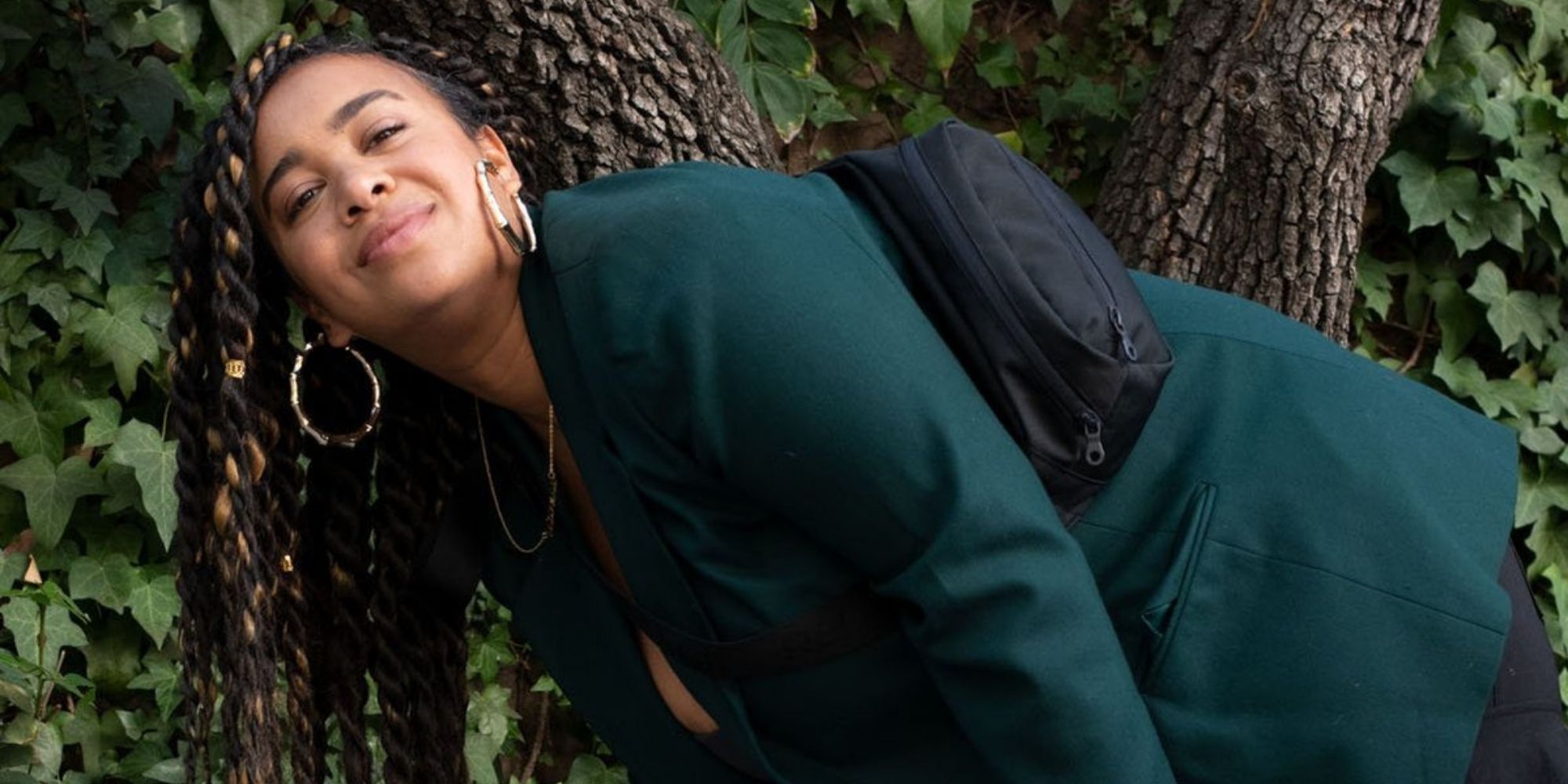 woman of colour wearing black sustainable bum bag by Girlfriend Collective