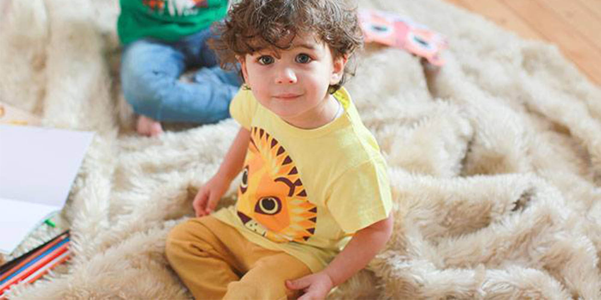 baby wearing yellow coq en pate tshirt