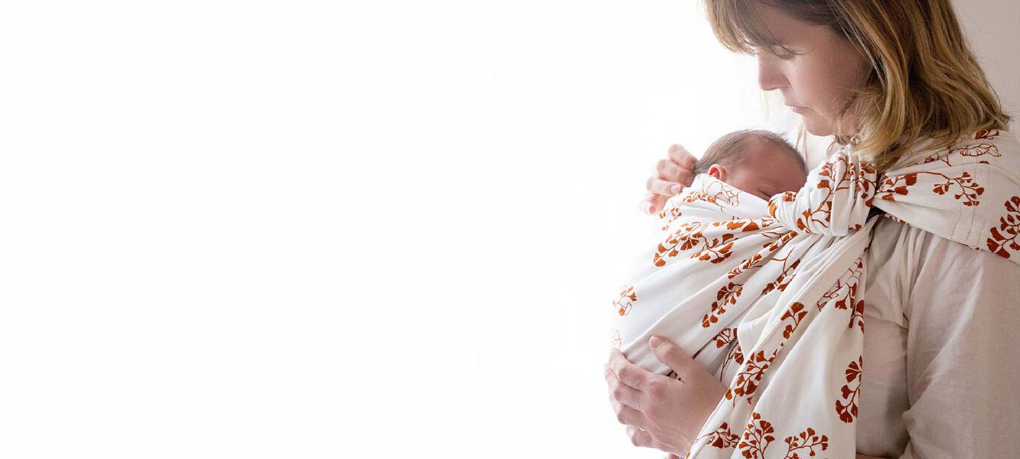 woman carrying baby in cloth
