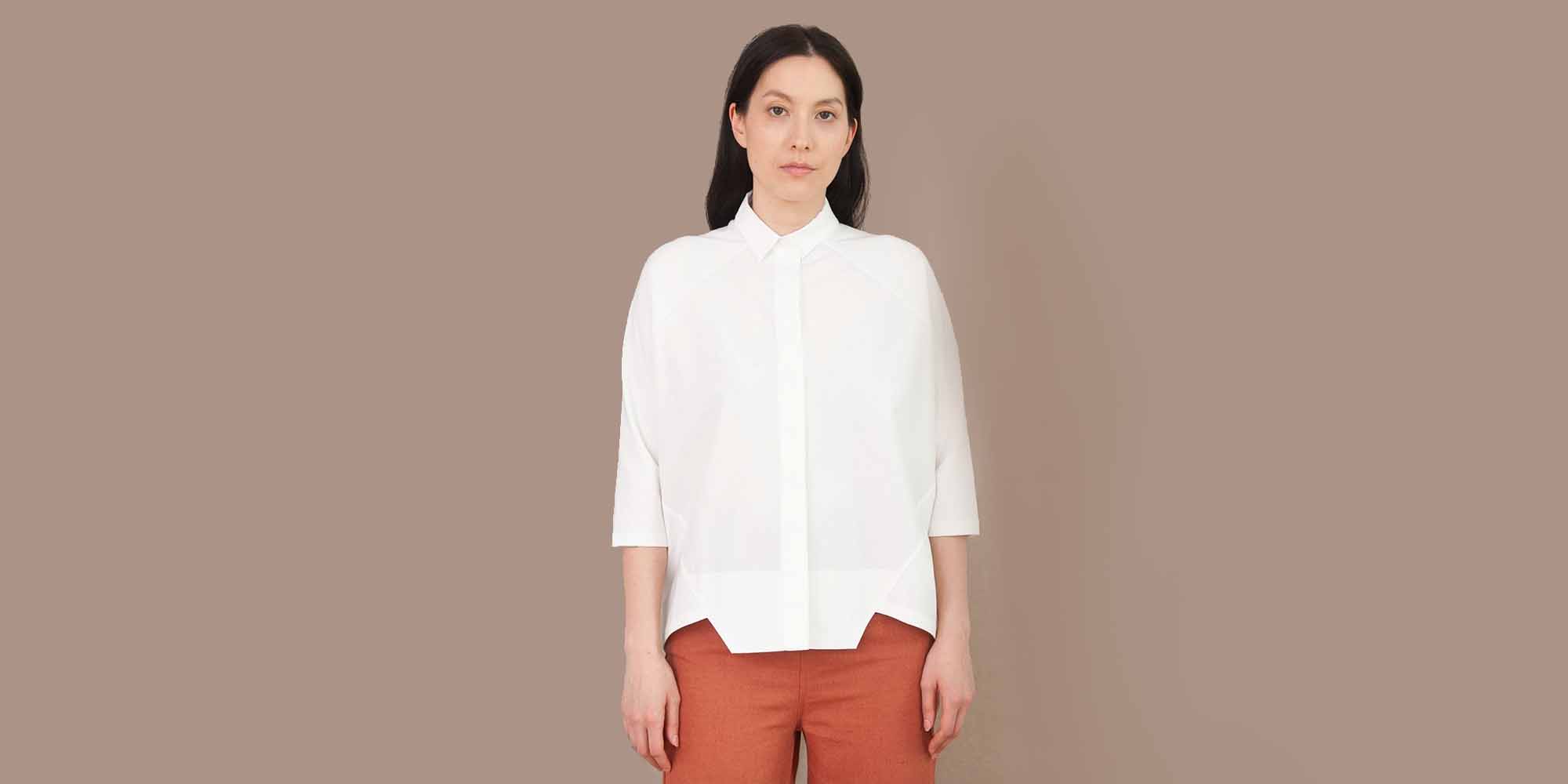 woman wearing white button up shirt by ethical brand beaumont organic