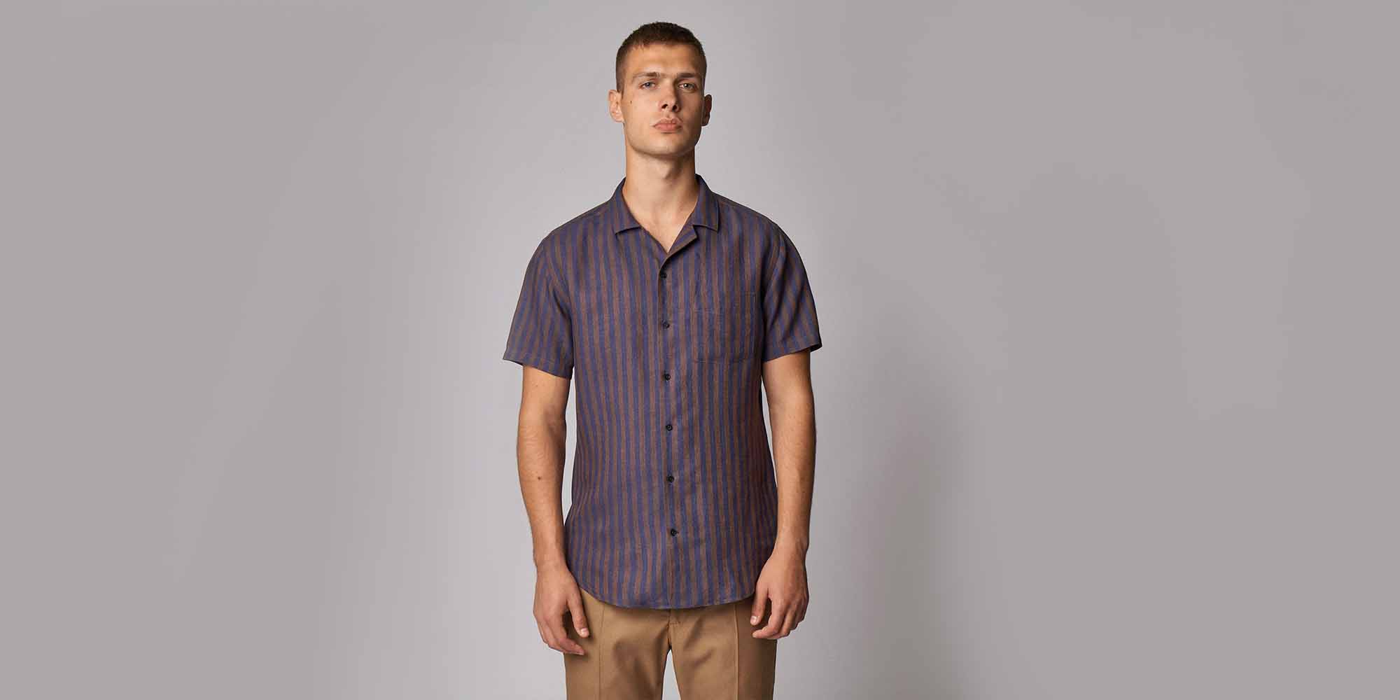 man wearing striped organic linen shirt by sustainable brand CARPASUS