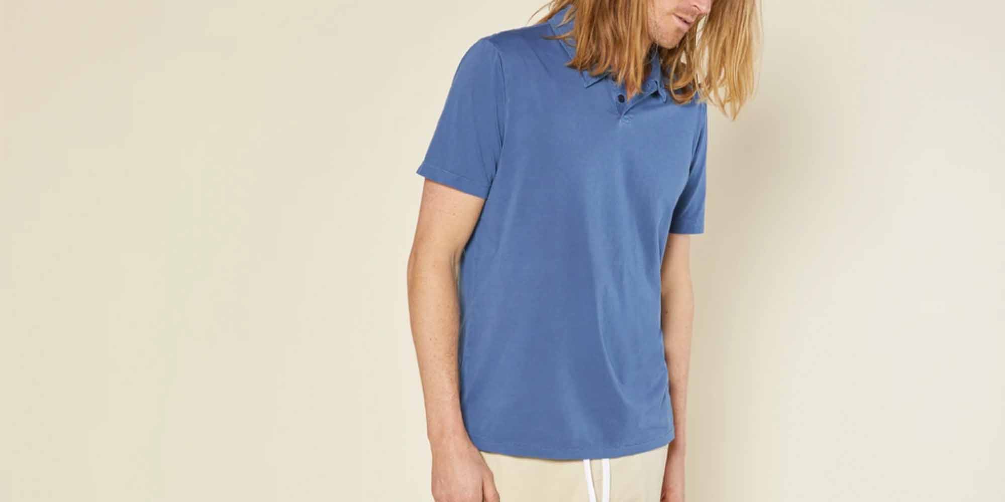 man wearing blue polo by ethical fashion men's brand outerknown