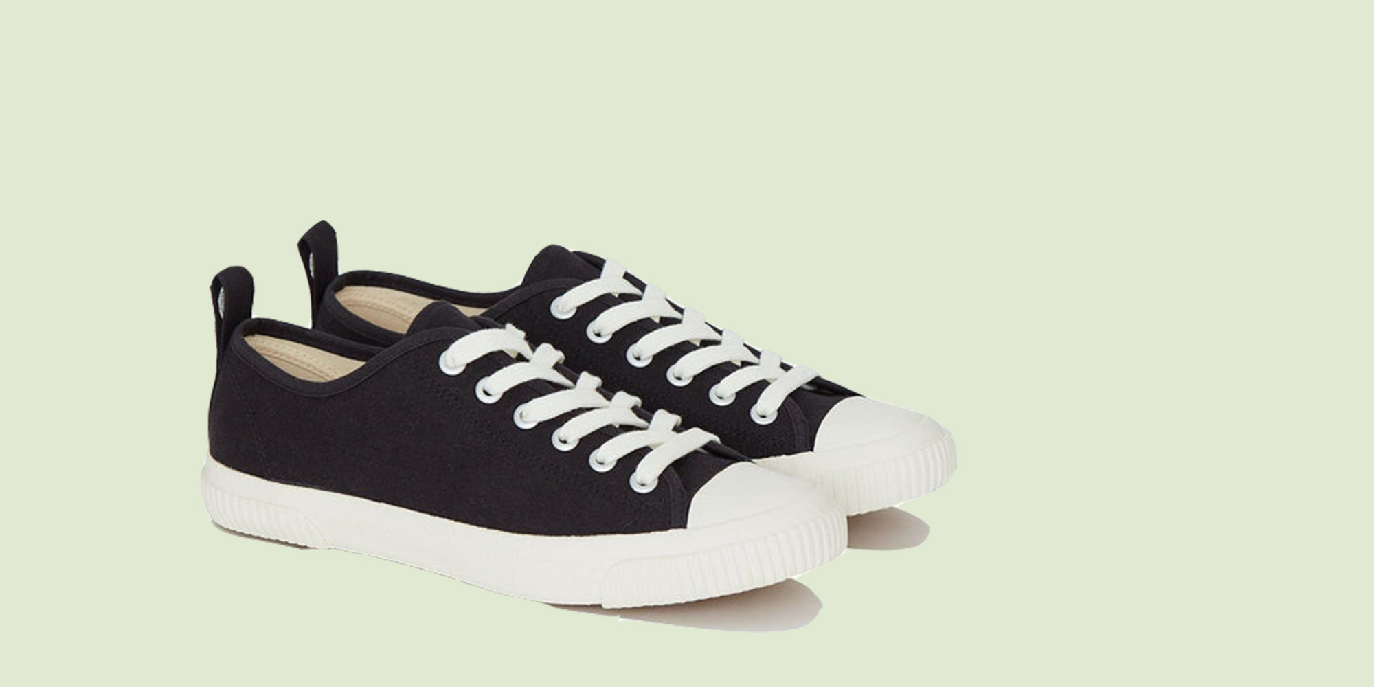Black low top sneakers by Komodo