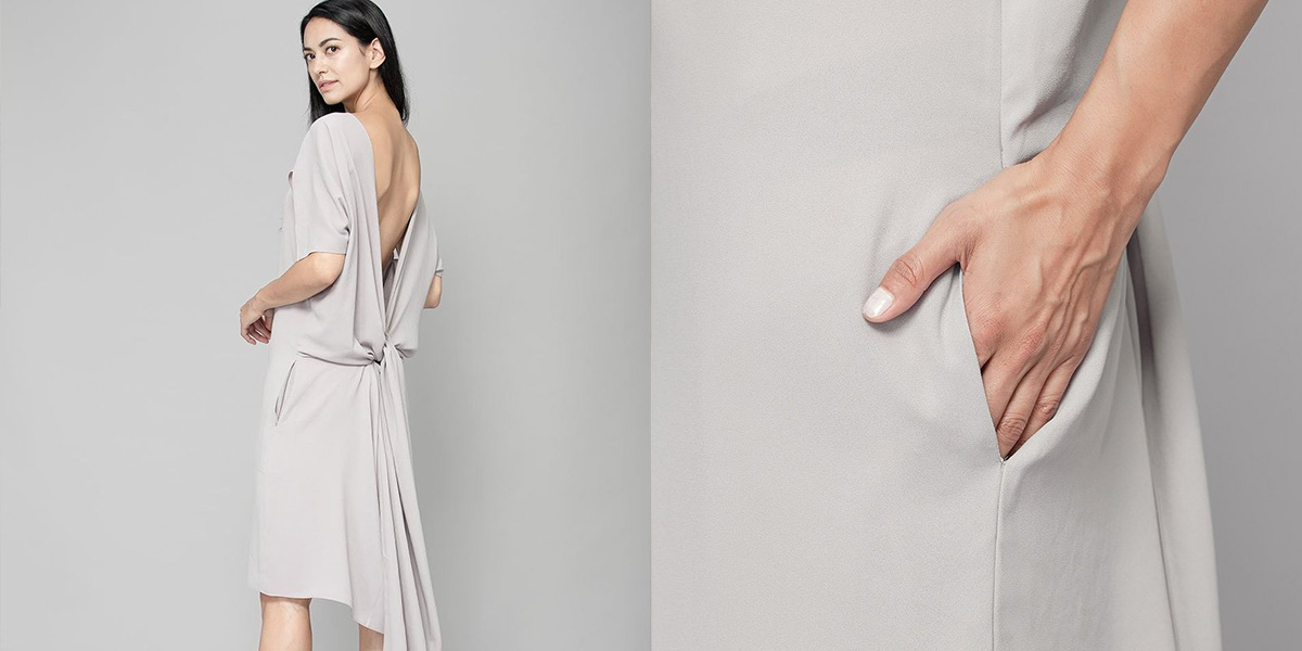 woman wearing beige sustainable dress by the r collective