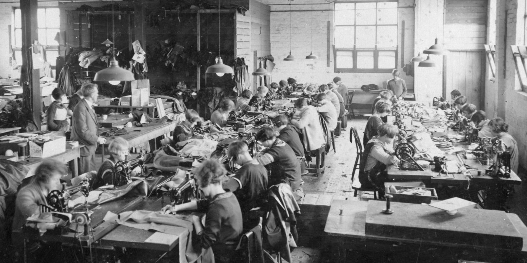 black and white photo of fast fashion garment workers in an old factory