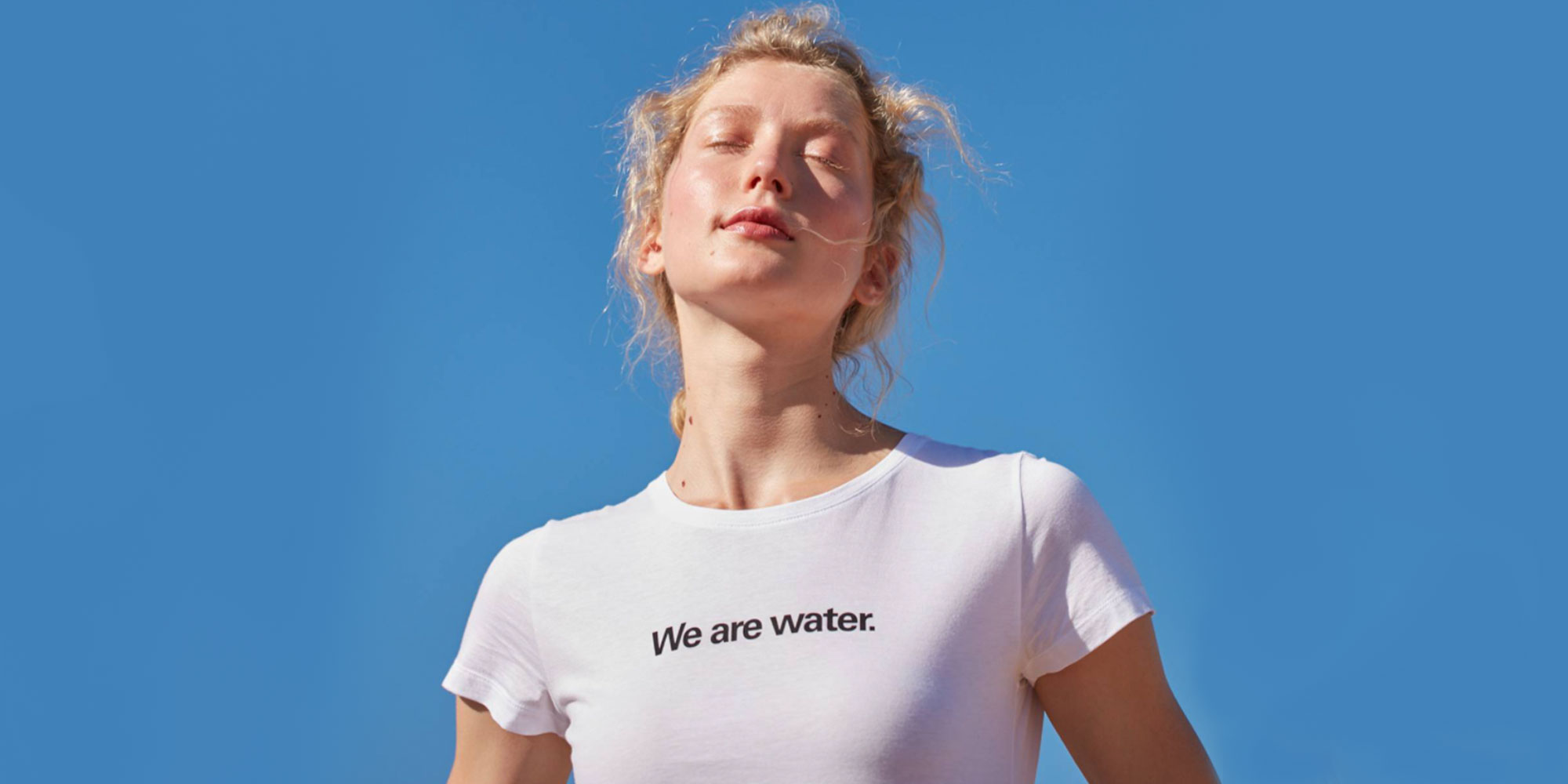 woman wearing We Are water slogan t-shirt