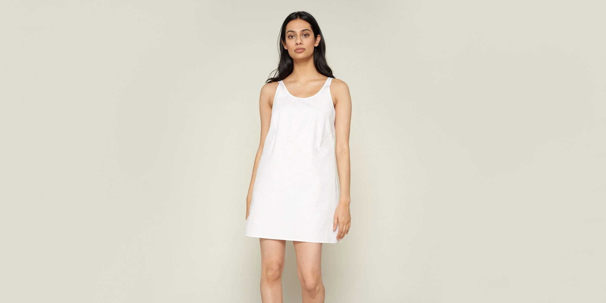 woman wearing white slip dress by GRAMMAR