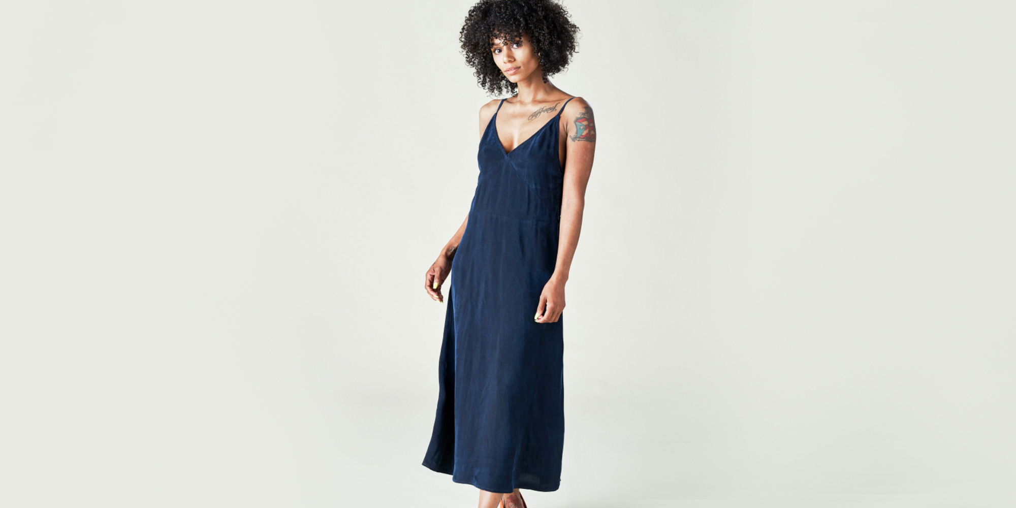 woman wearing navy slip dress by left edit