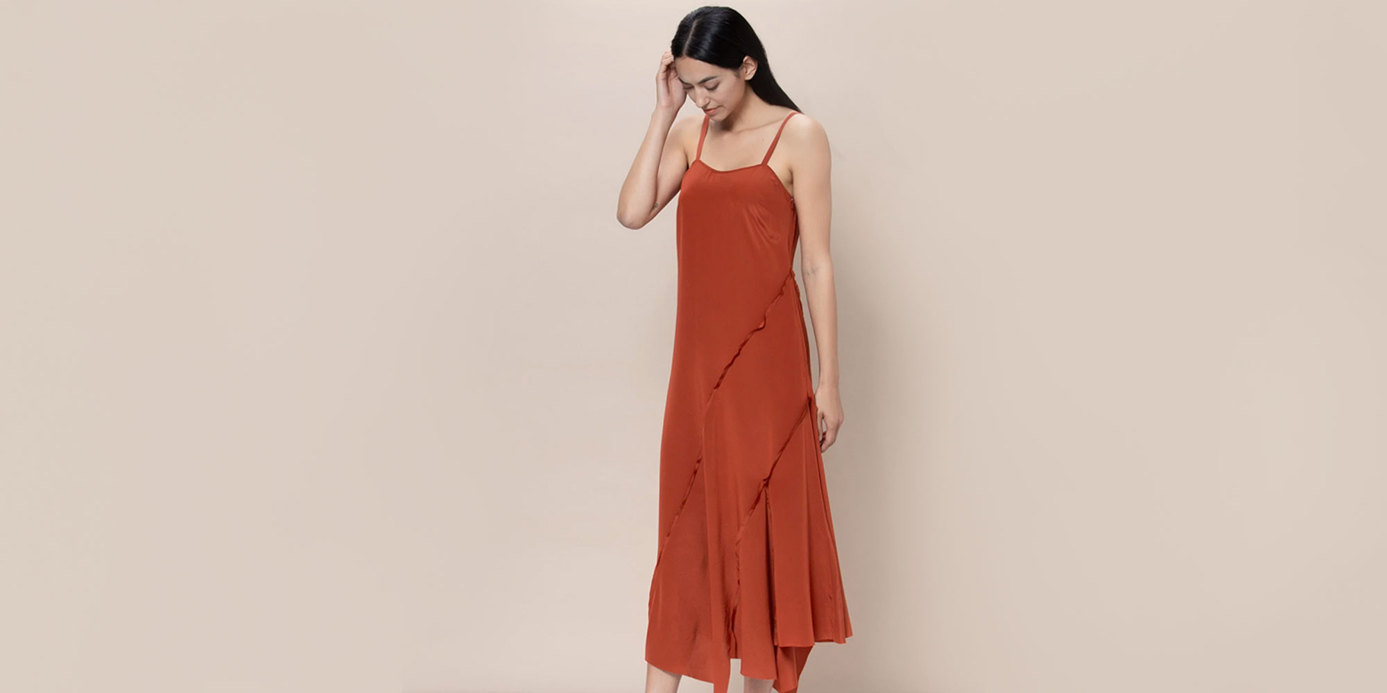 woman wearing rusty sustainable slip dress by r collective