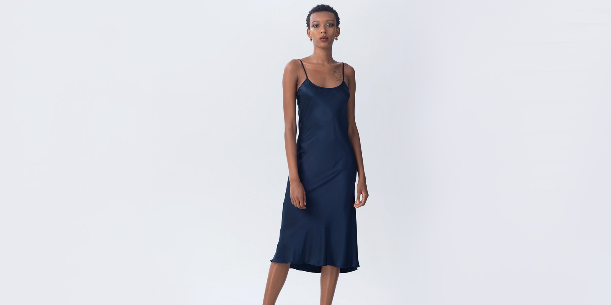 woman wearing navy slip dress by voz