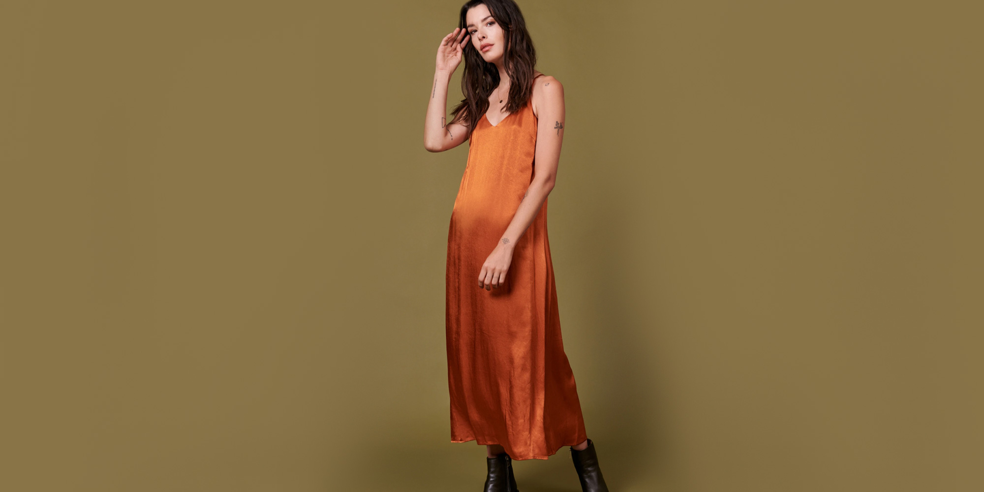 woman wearing orange ethical slip dress by whimsy + row