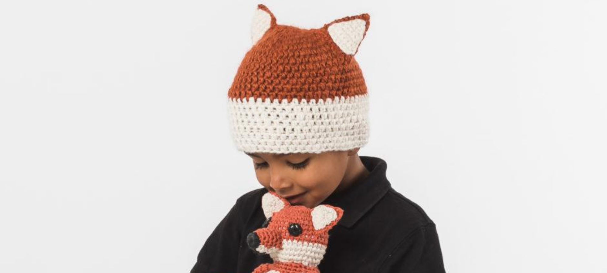 boy wearing knitted fox beanie by ethical brand Krochet Kids