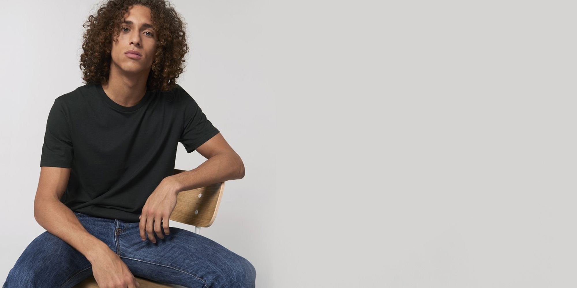 man wearing sustainable back t-shirt by brothers we stand