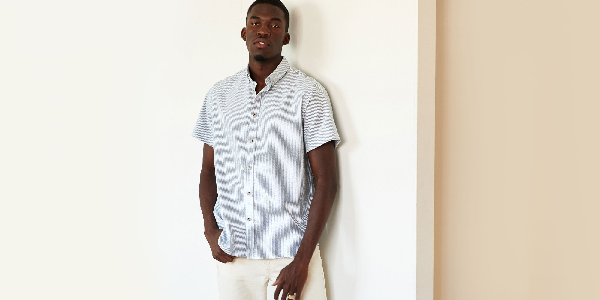 man wearing striped ethical shirt by Kotn