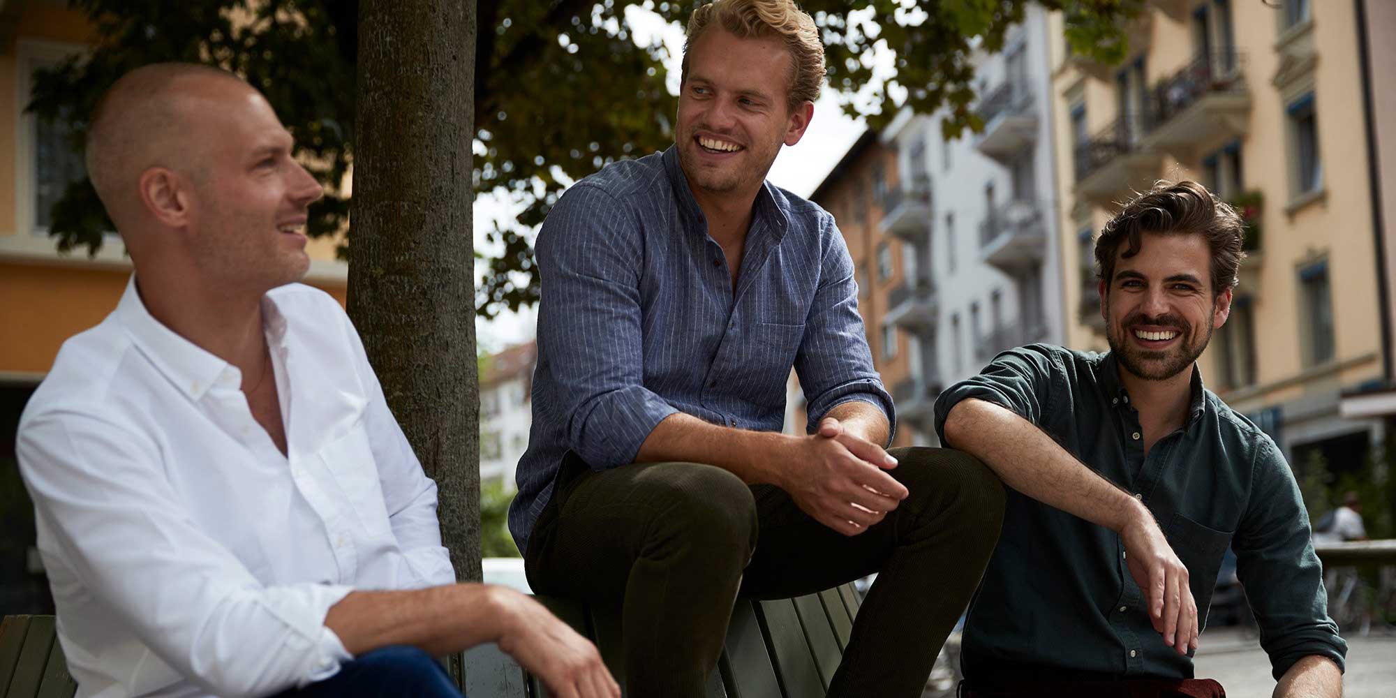 three men smiling in their eco friendly men's shirts by CARPASUS