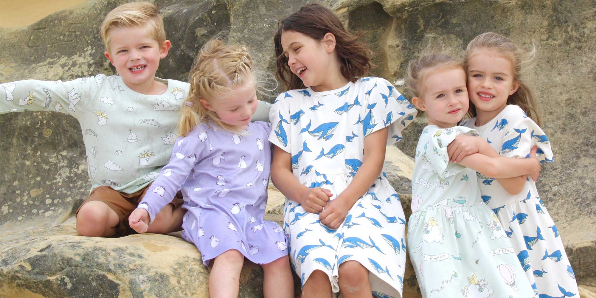 group of children wearing sustainably made print dresses from Little Emperor