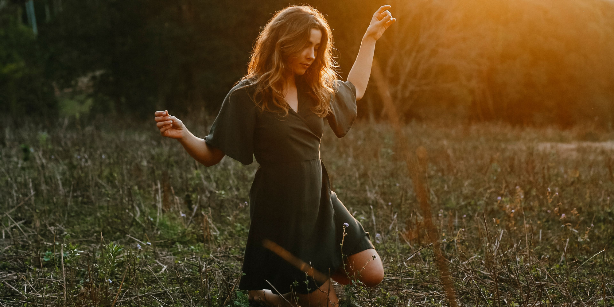 Woman wearing green more sustainable TENCEL wrap dress by responsible brand Tasi Travels.