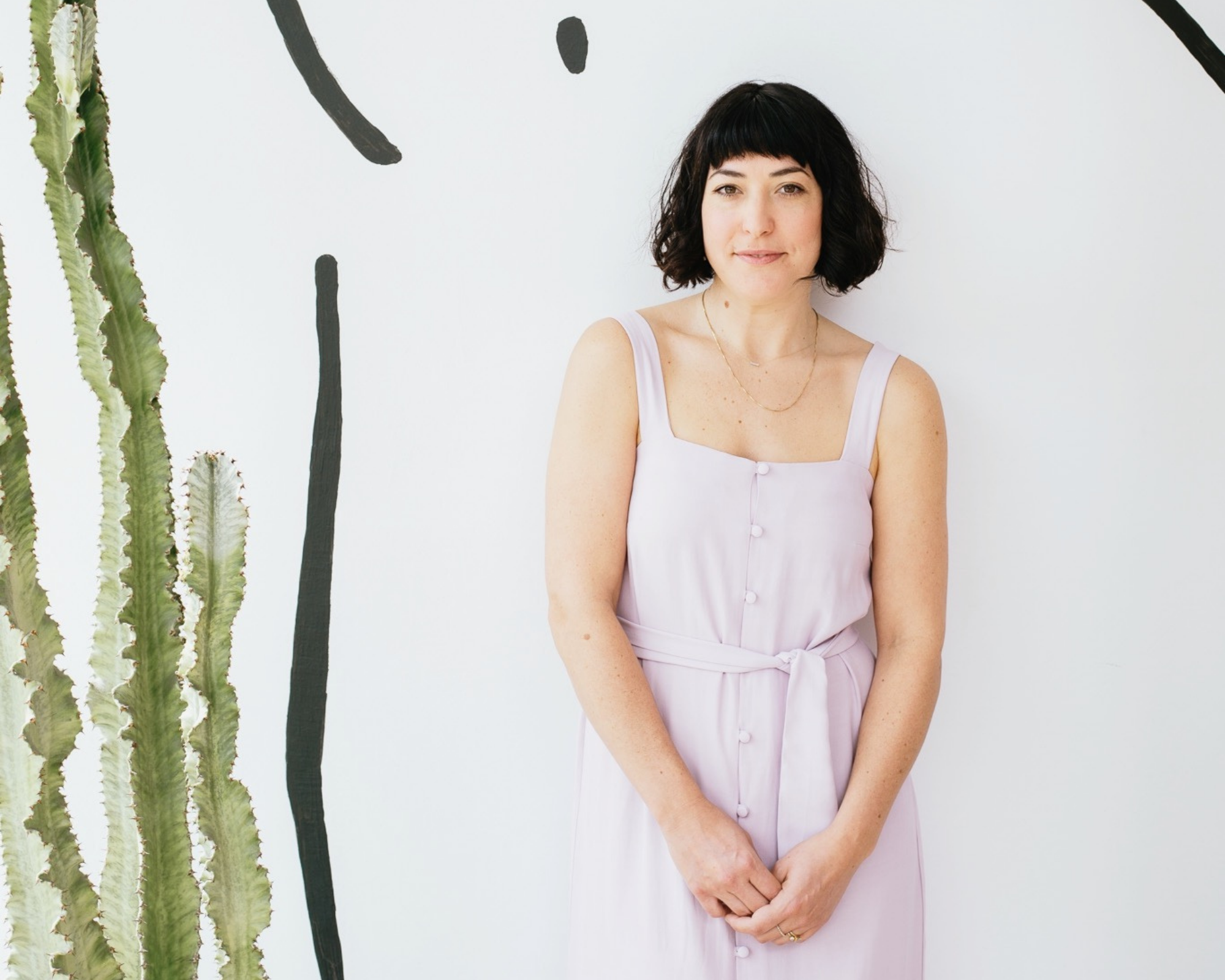 Whimsy + Row founder Rachel Temko wearing pink sustainable dress in front of white background