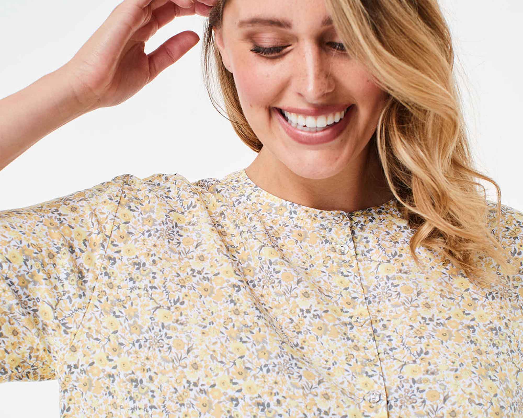 woman wearing light flowery blouse by kmart australia