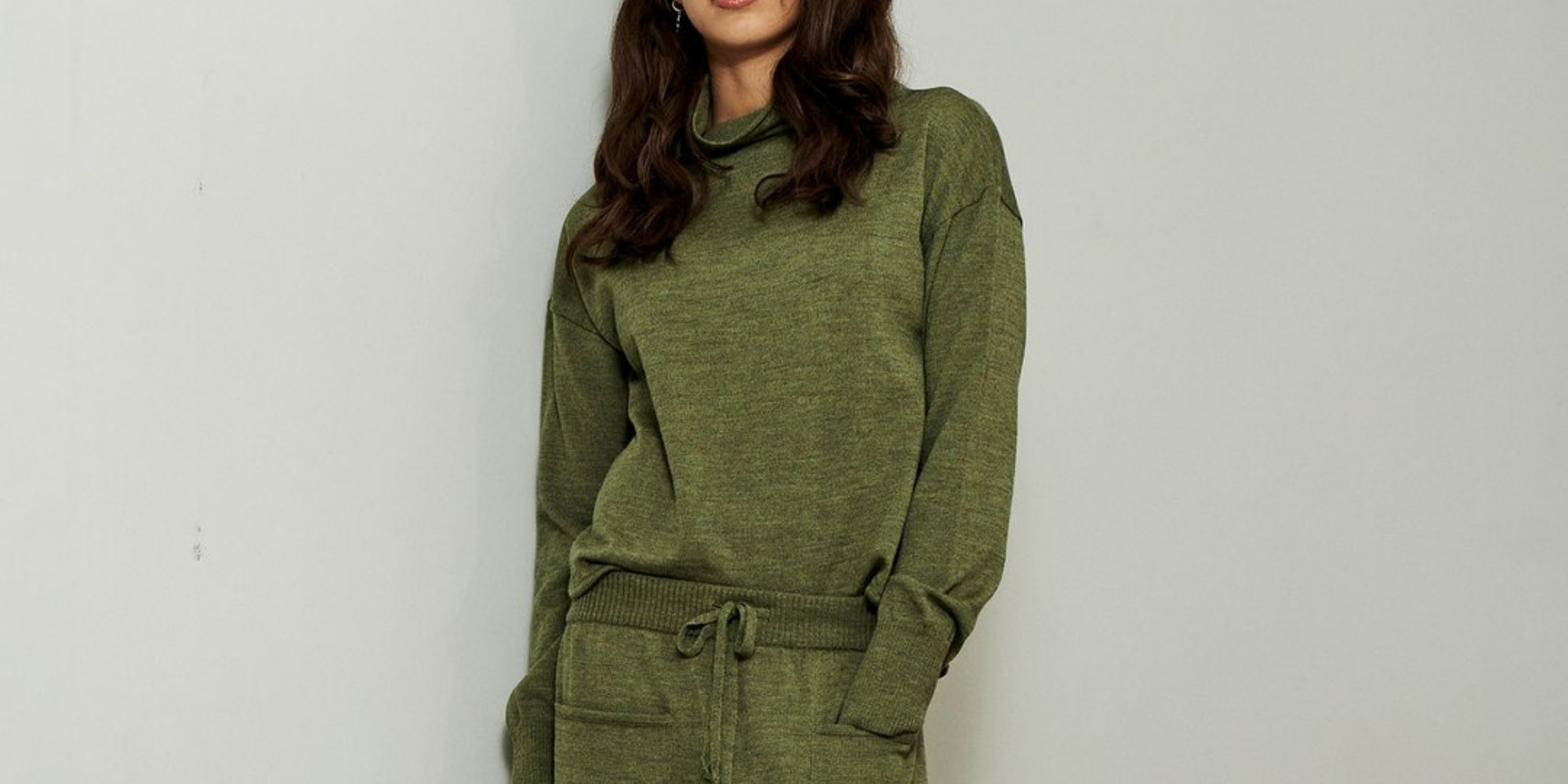woman of colour wearing green sustainable loungewear by Underprotection