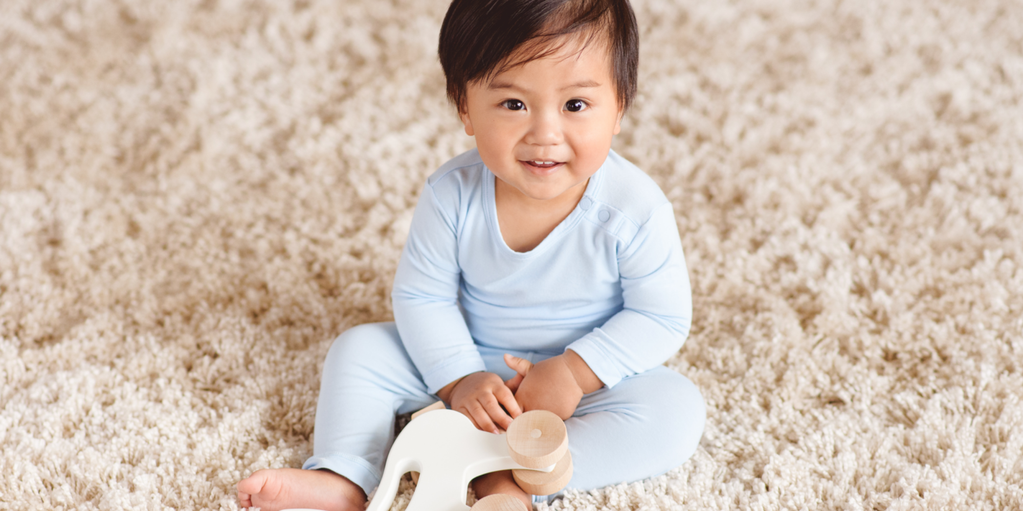 Asian baby wearing light blue sustainable baby wear from Boody