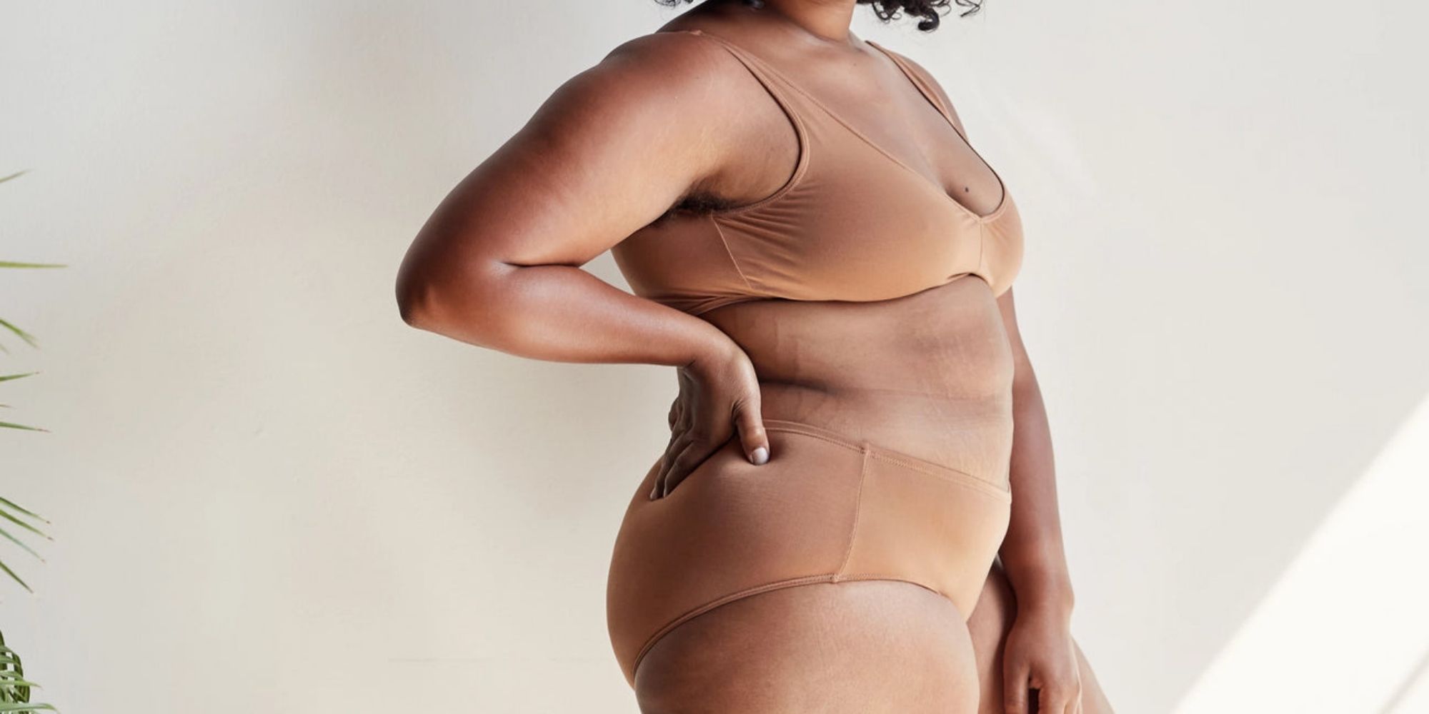 Someone wearing a TENCEL underwear set by Proclaim that matches their medium skin shade.