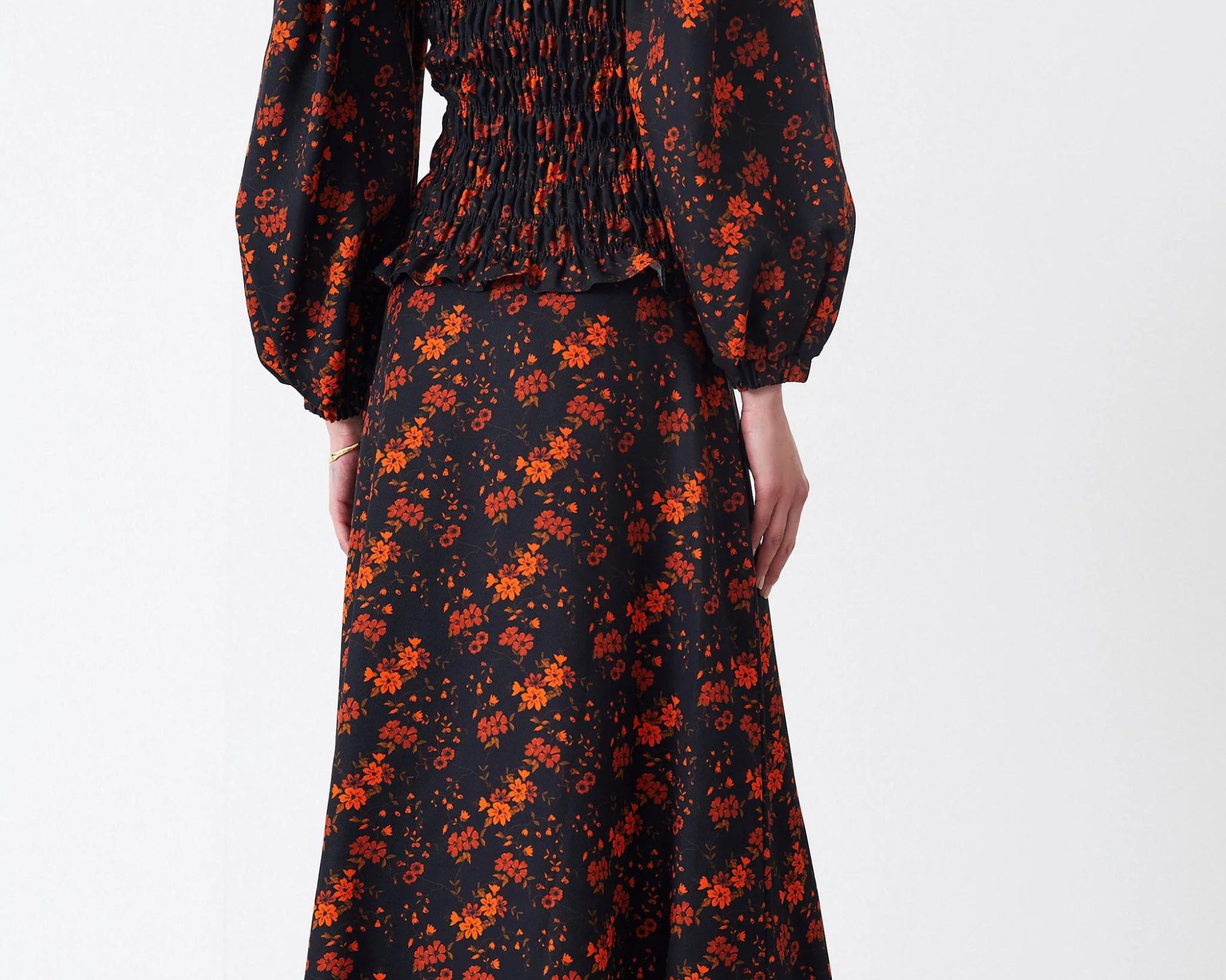 A black orange blossom print TENCEL Lyocell skirt by Mother of Pearl.