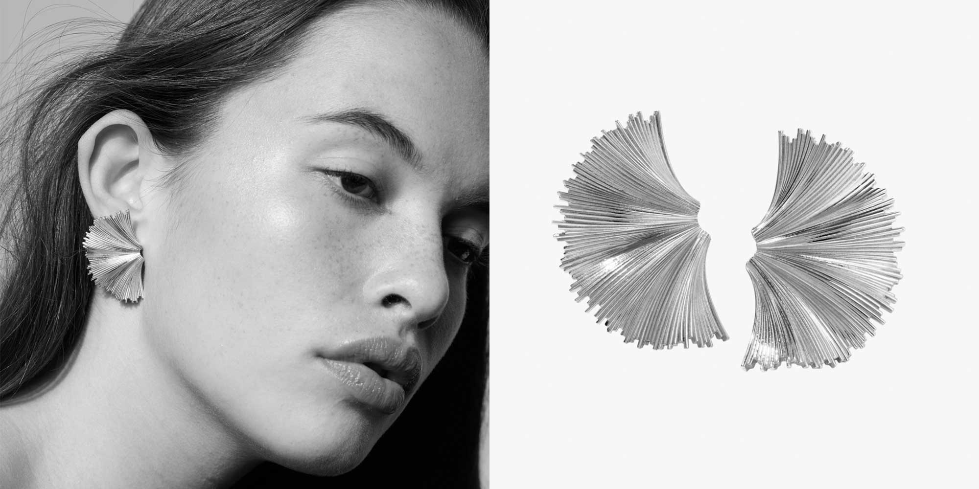 woman wearing silver large fan earrings by meadowlark