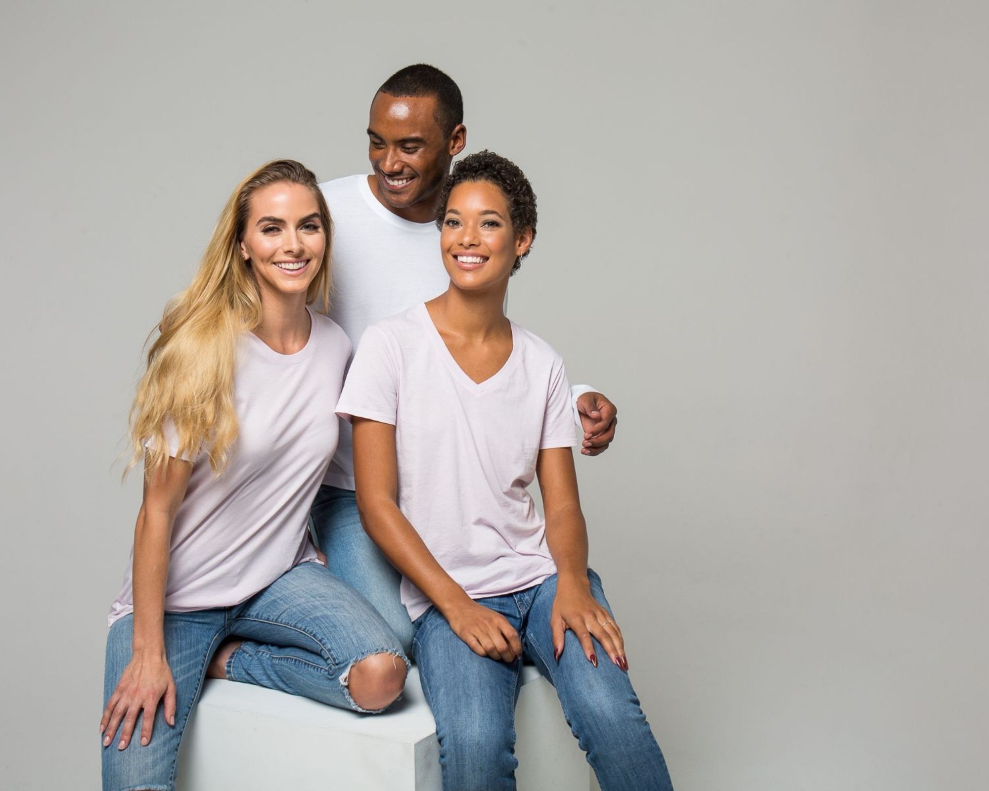 group of three people smiling and wearing organic cotton tshirts by The Classic T-Shirt Company