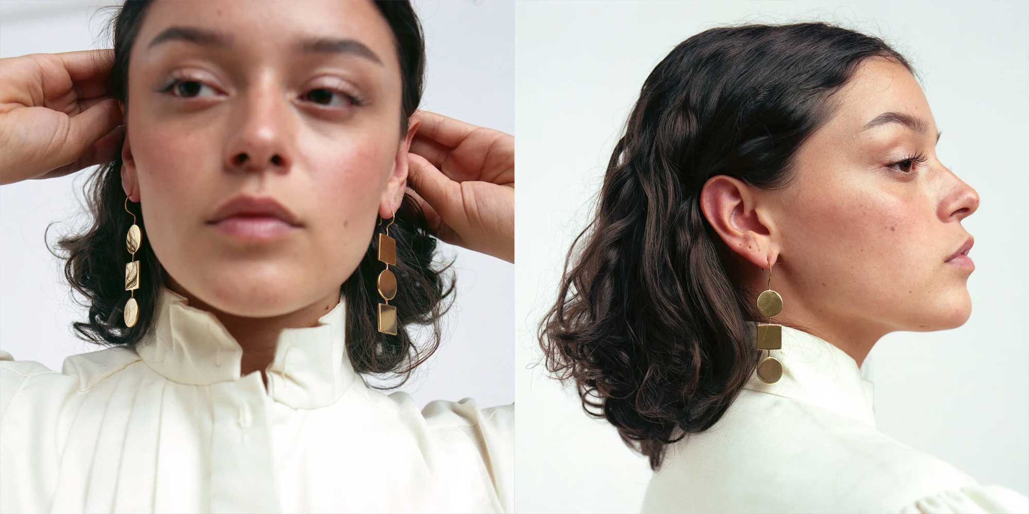 A pair of long geometric gold earrings by Raven + Lily.