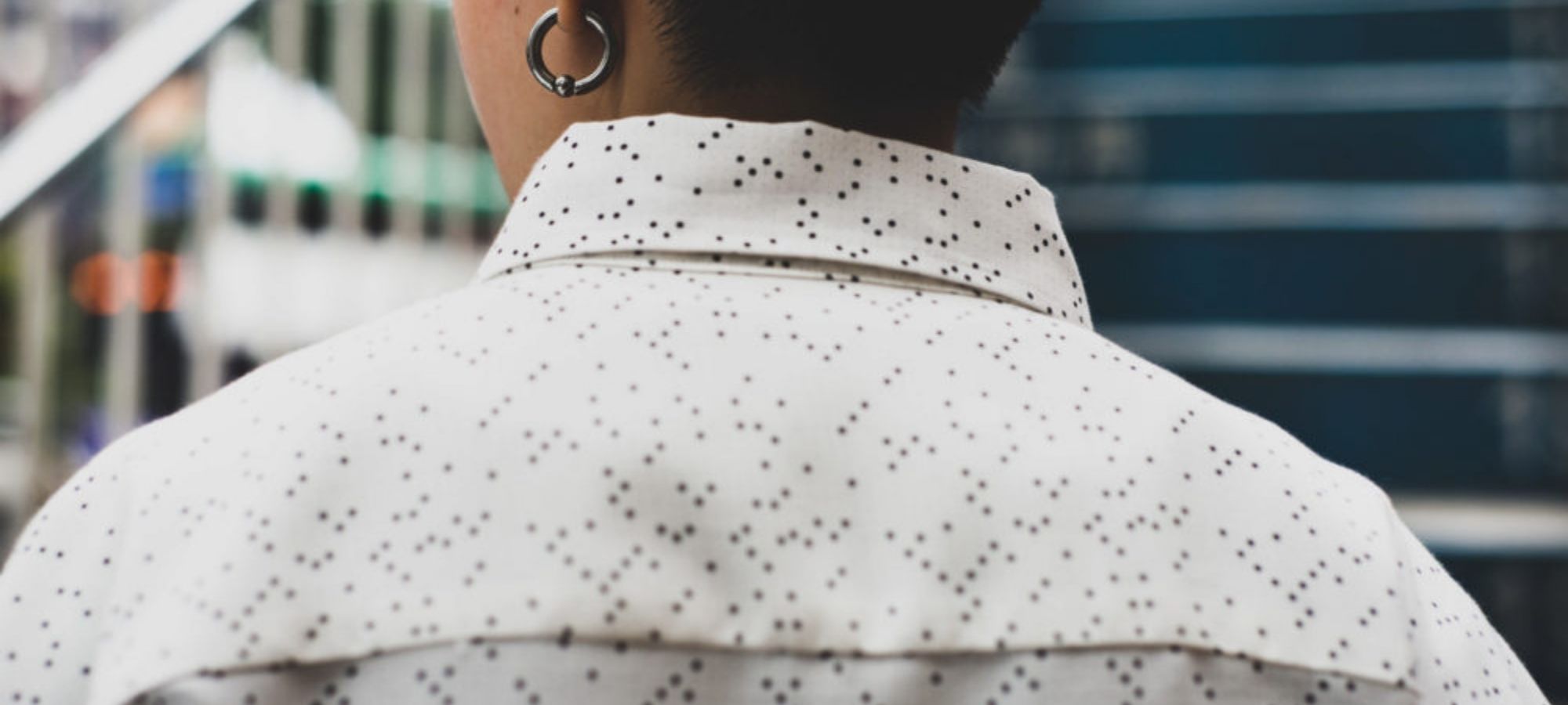 person wearing unisex white collared shirt with black dots by AndAll