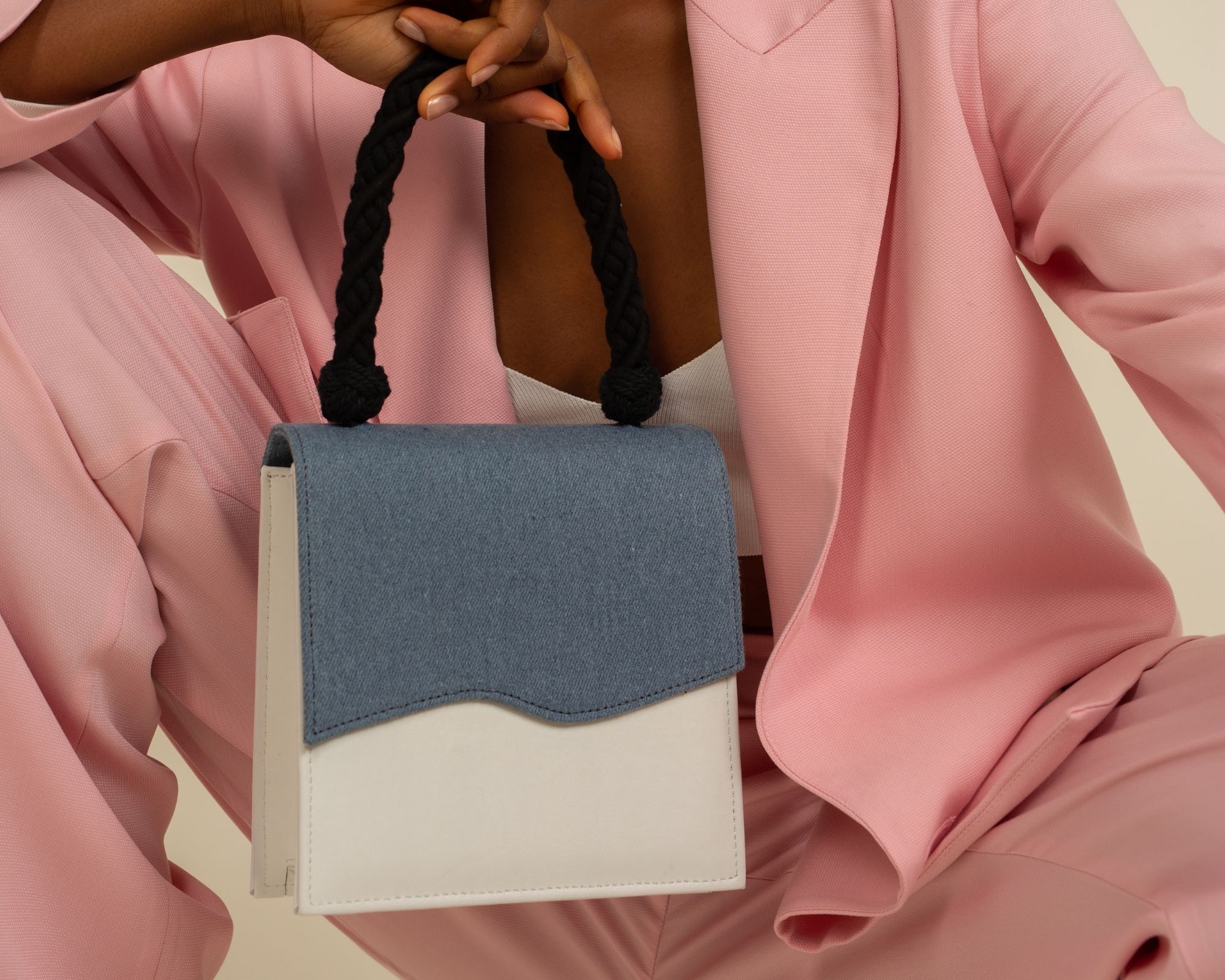 woman of colour holding blue and white sustainable handbag by Mashu