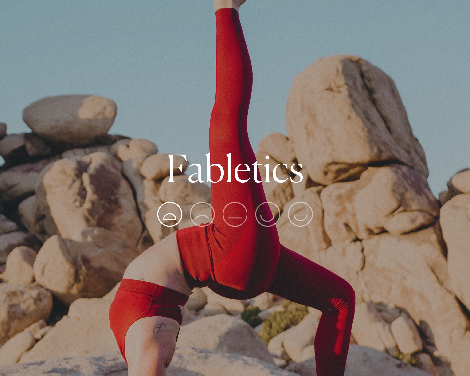 Someone outdoors doing a yoga pose in a set of red activewear behind the word Fabletics with a highlighted sad face emoji.