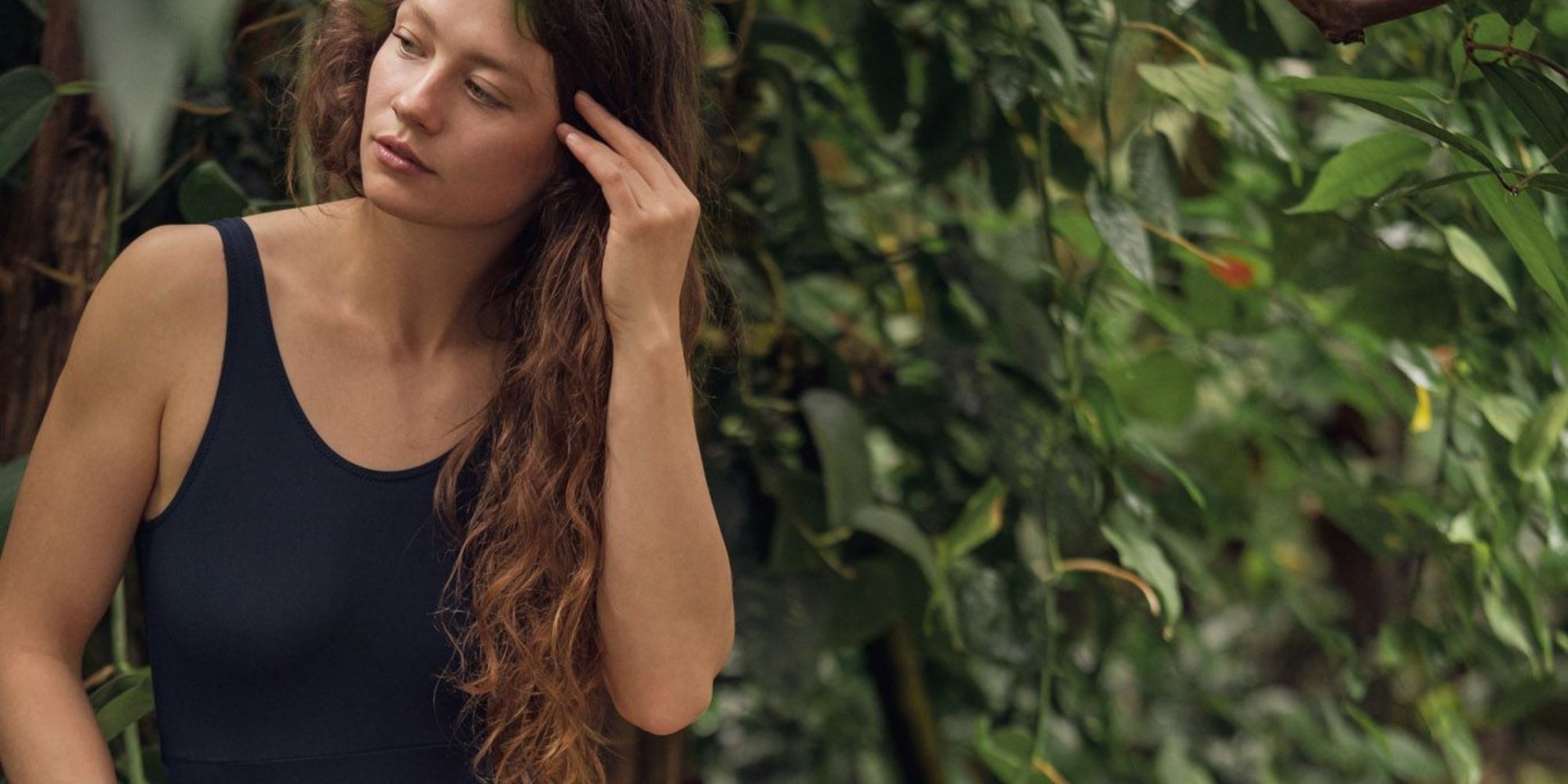 woman wearing black eco swimsuit by bleed