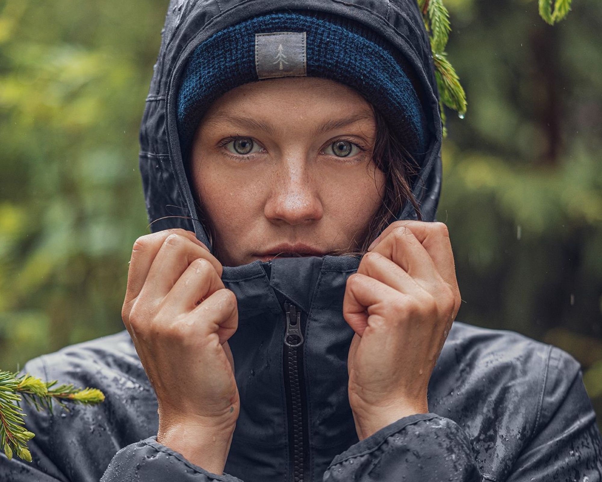 woman wearing bleed's sustainable outdoor jacket in blue