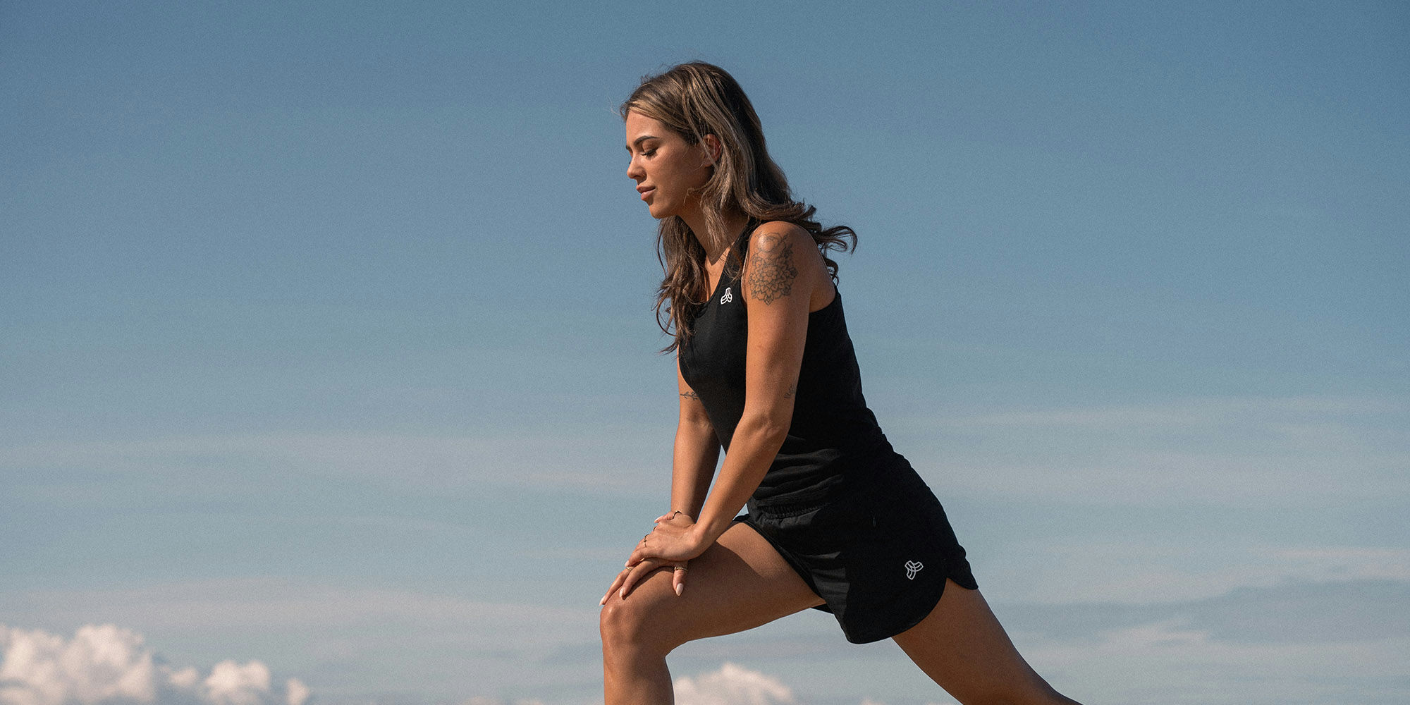 Someone in top and shorts by Iron Roots.