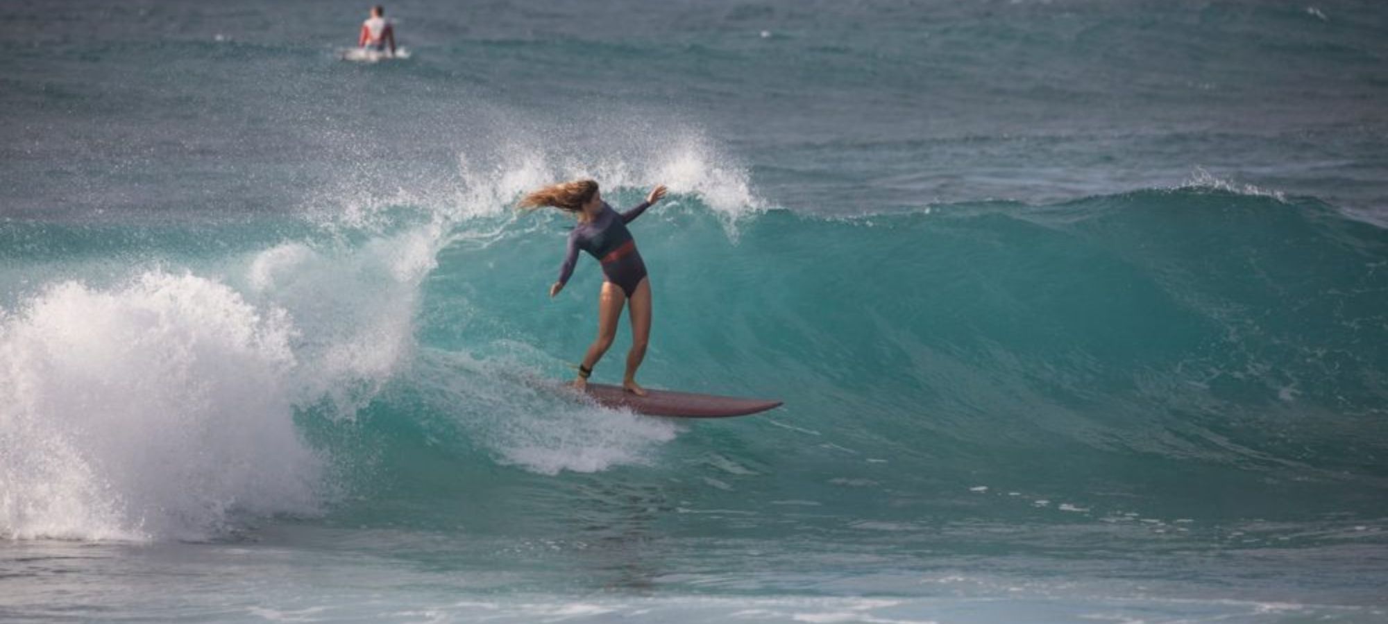 person surfing in sustainable surfwear by Seea