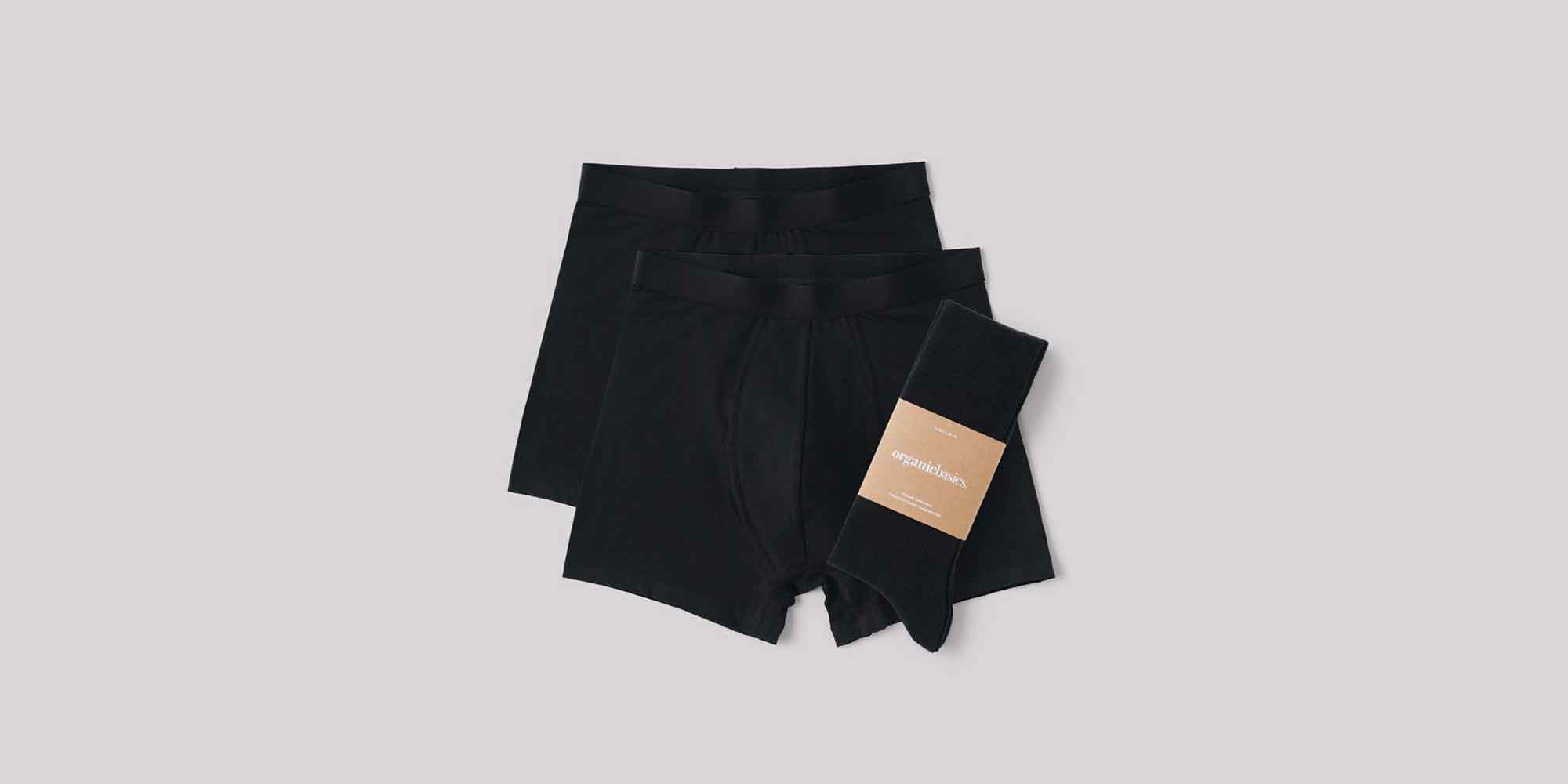 two pairs of black sustainable wardrobe essentials boxers and a pair of ethical black socks by Organic Basics