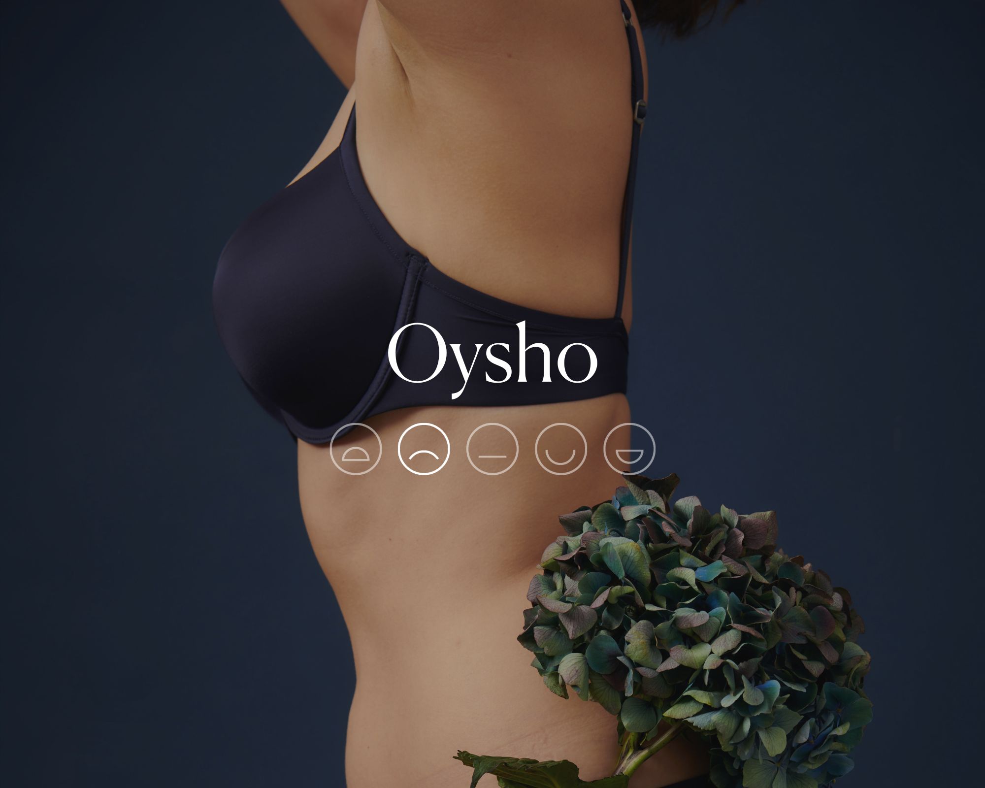 A navy blue lingerie set behind white text reading Oysho and a highlighted sad emoji face.